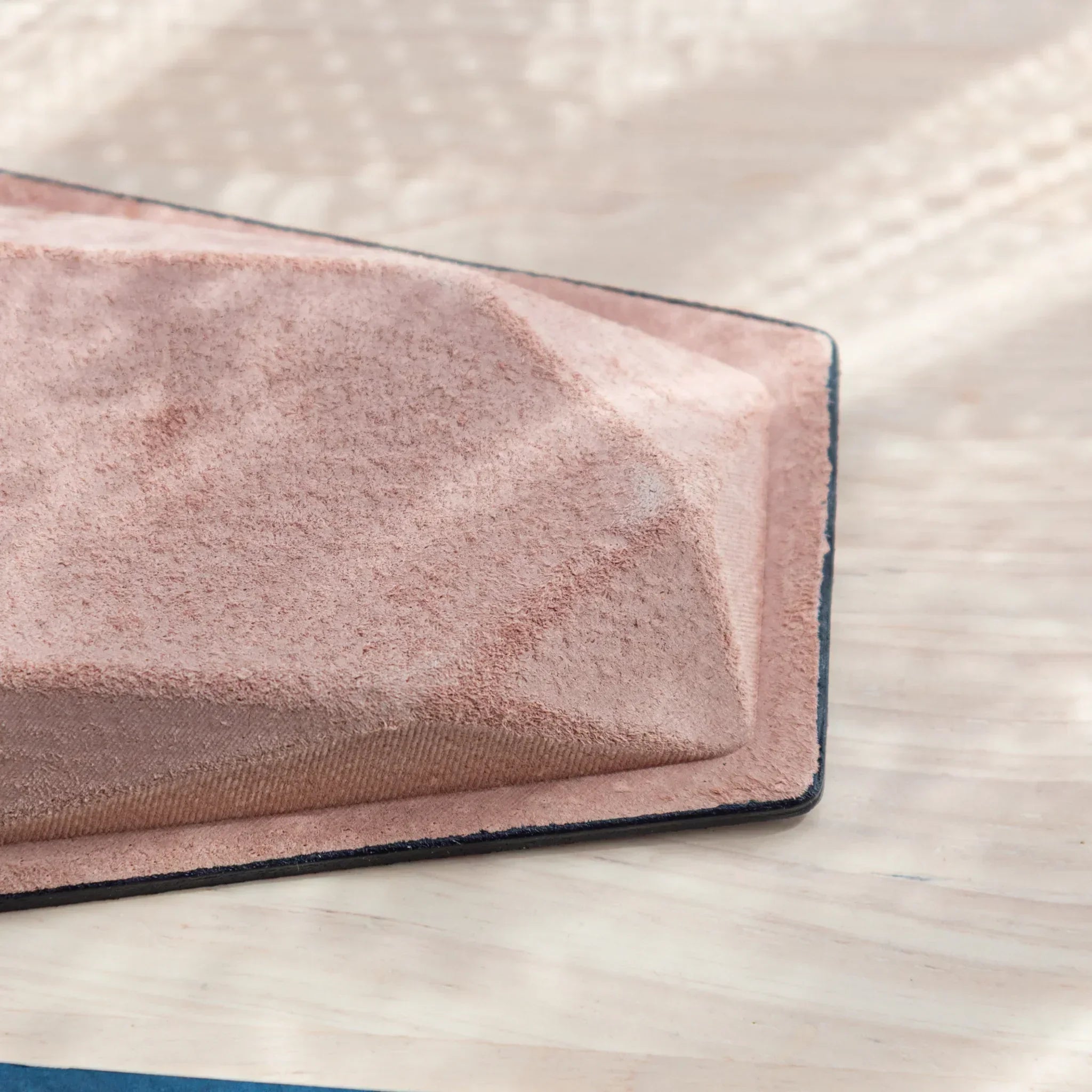Corner detail of Japanese Pen Tray, showing pink suede texture and stitched edge.