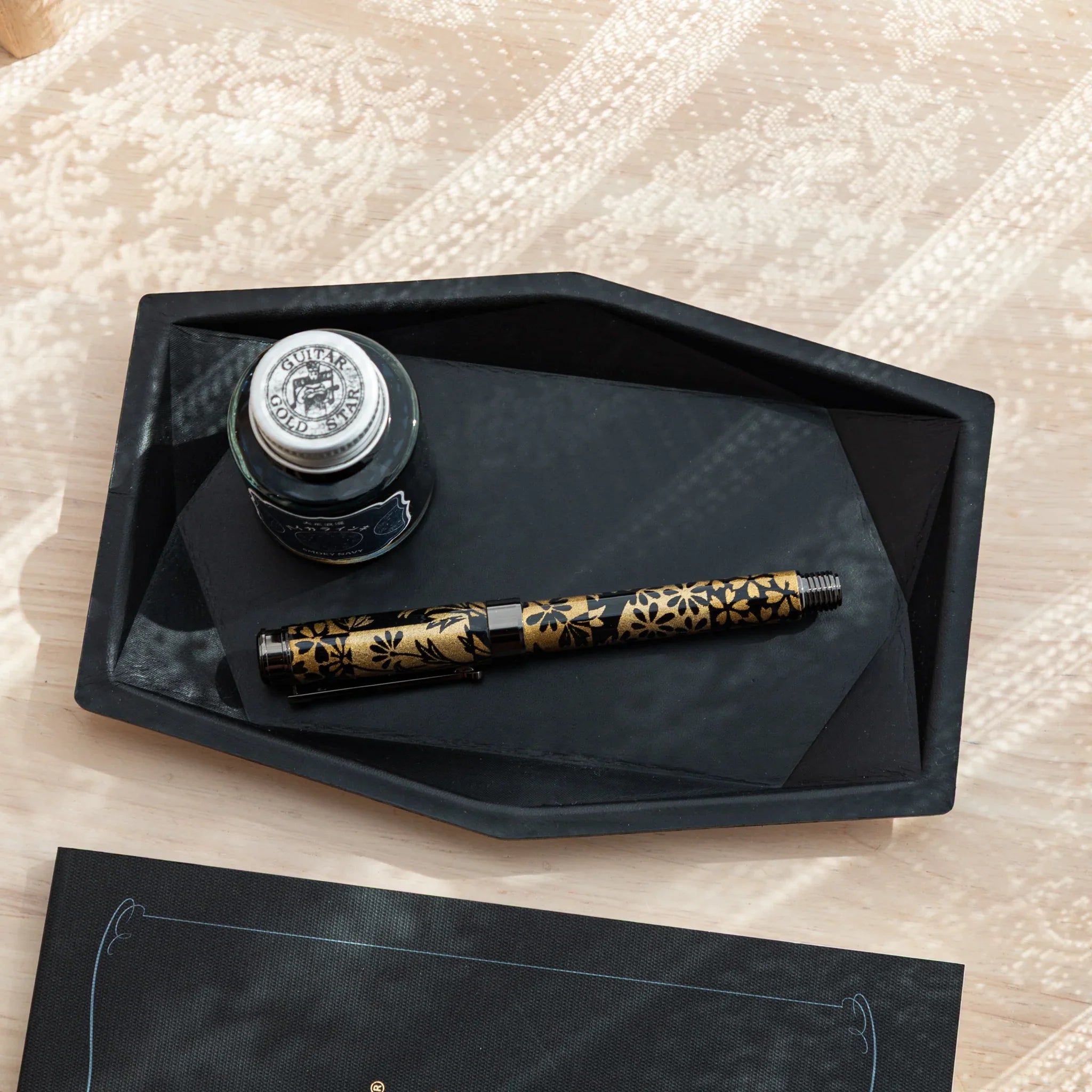 Japanese Pen Tray with black suede surface holding two decorative Japanese fountain pen.