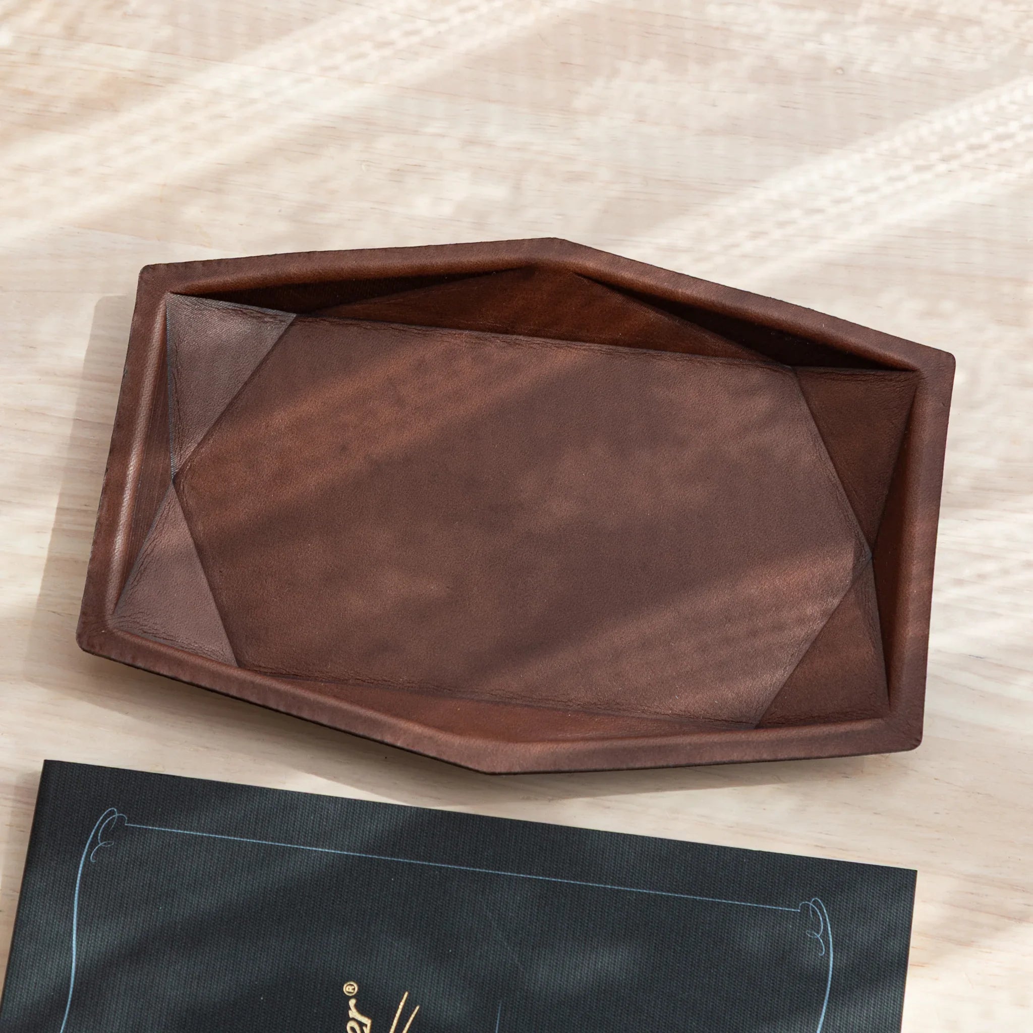 Orange leather hexagonal pen tray photographed from above showing the spacious hexagonal compartment storage space