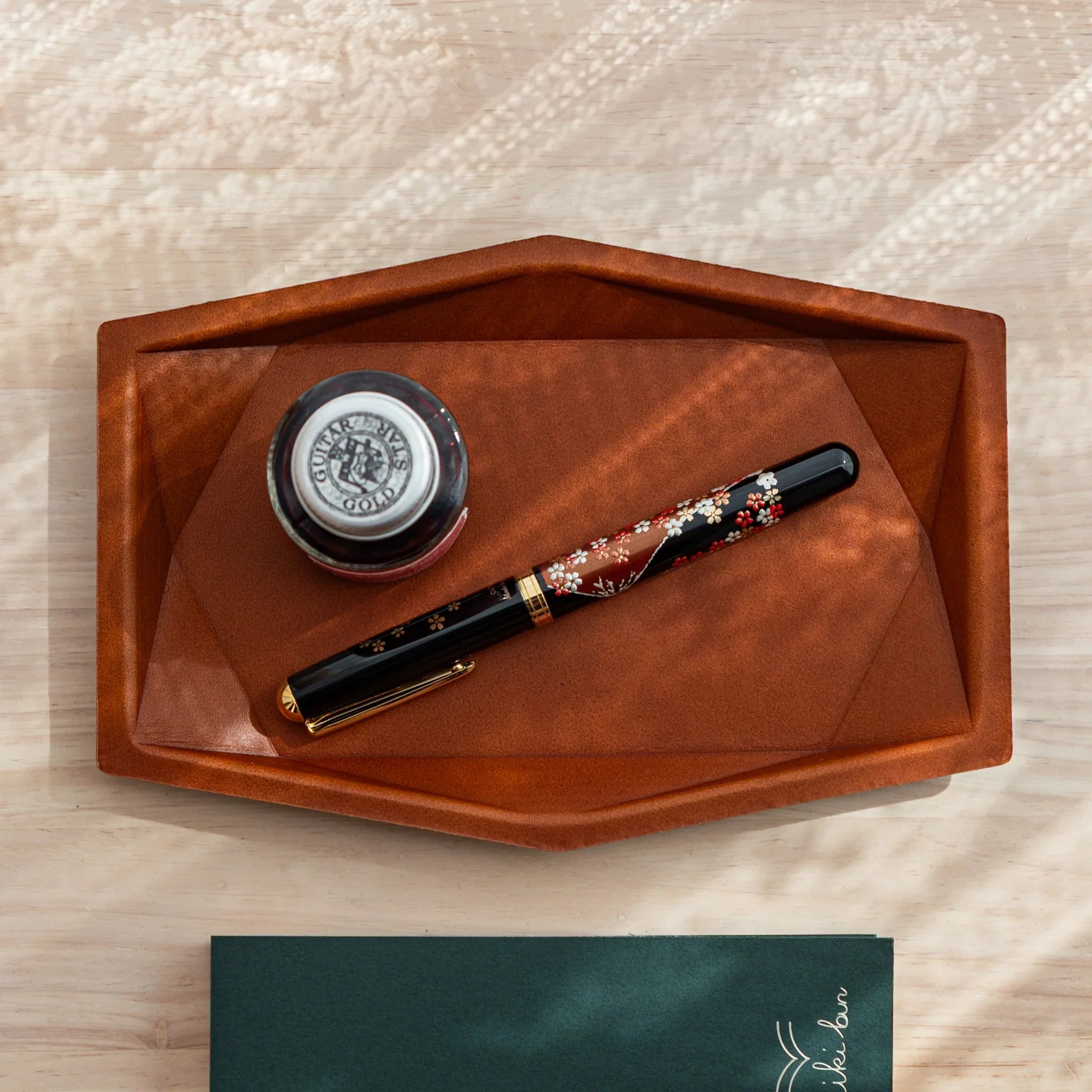 Tan hexagonal leather pen tray photographed from above displaying the spacious hexagonal storage compartment space