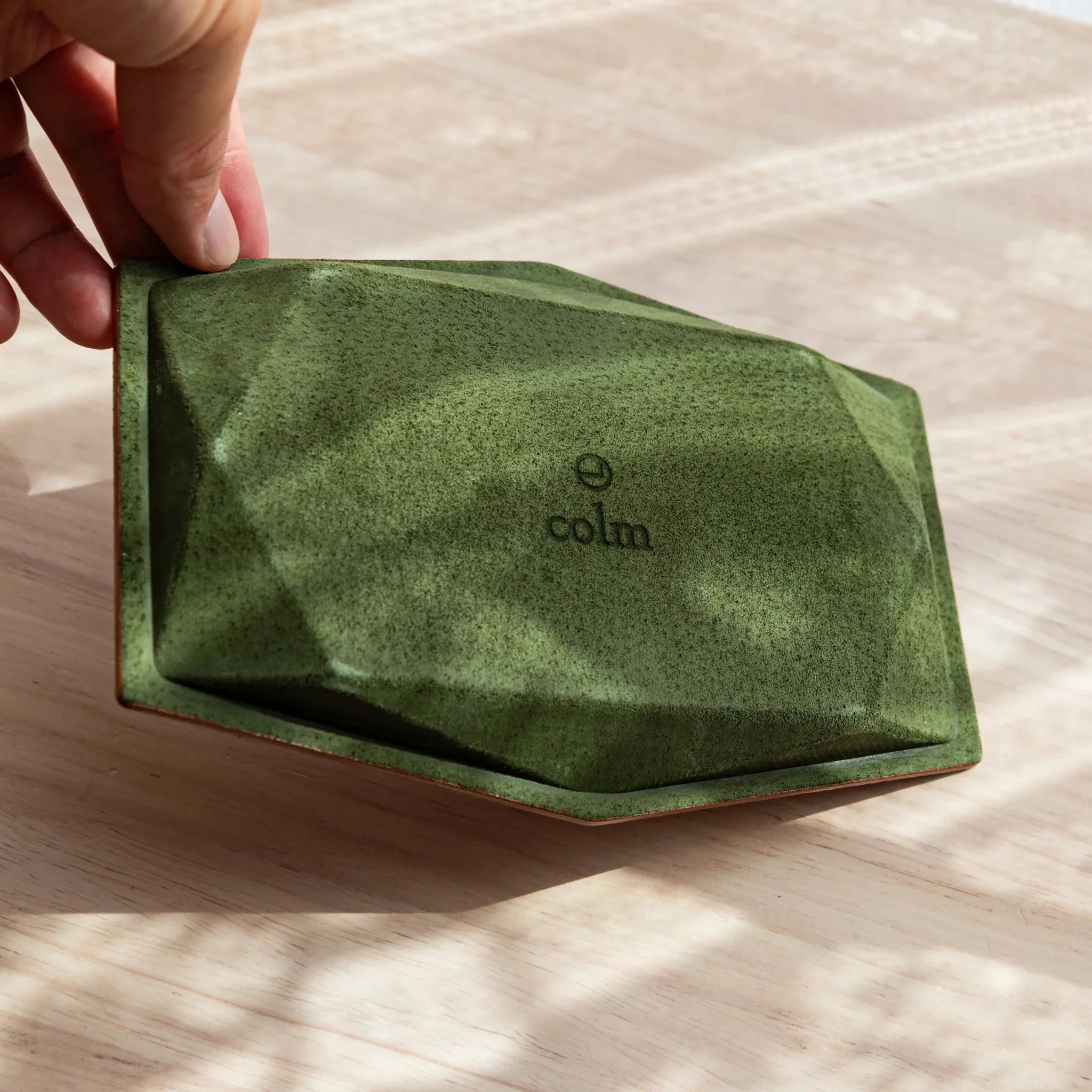 Tan hexagonal leather pen tray from side profile displaying distinctive hexagonal shaped form and construction clearly