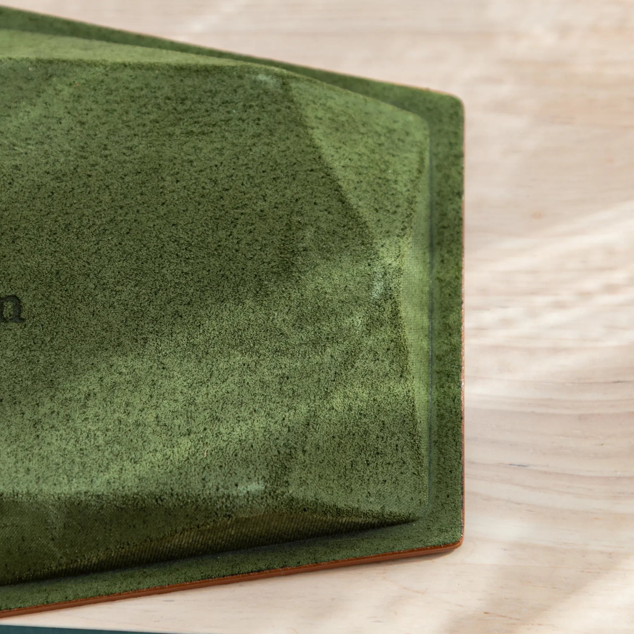 Gray hexagonal leather pen tray at angled perspective with distinctive hexagonal shape prominently displayed and visible