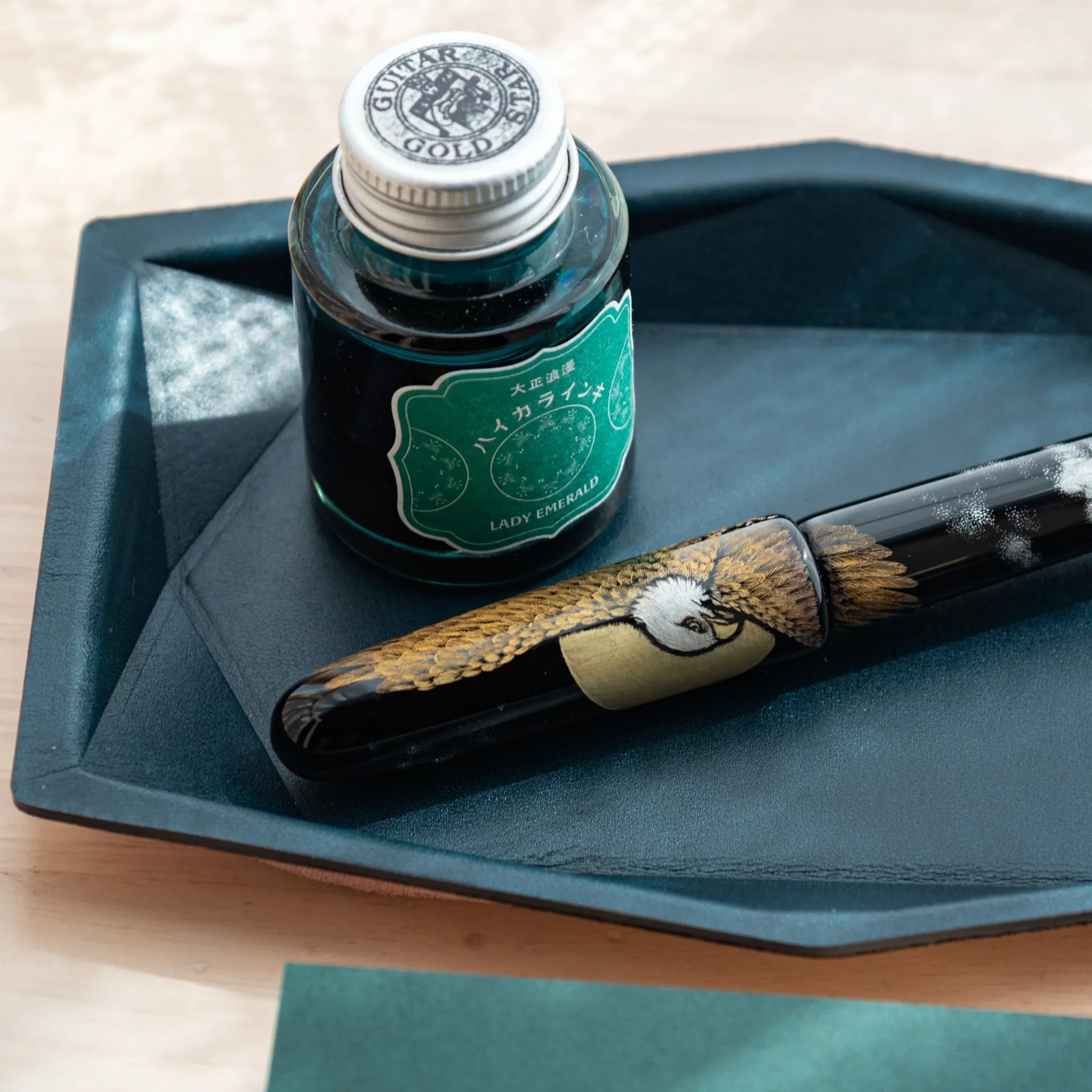 Close-up of Japanese Pen Tray in Teal-Blue leather with Japanese Fountain Pen and ink bottle.