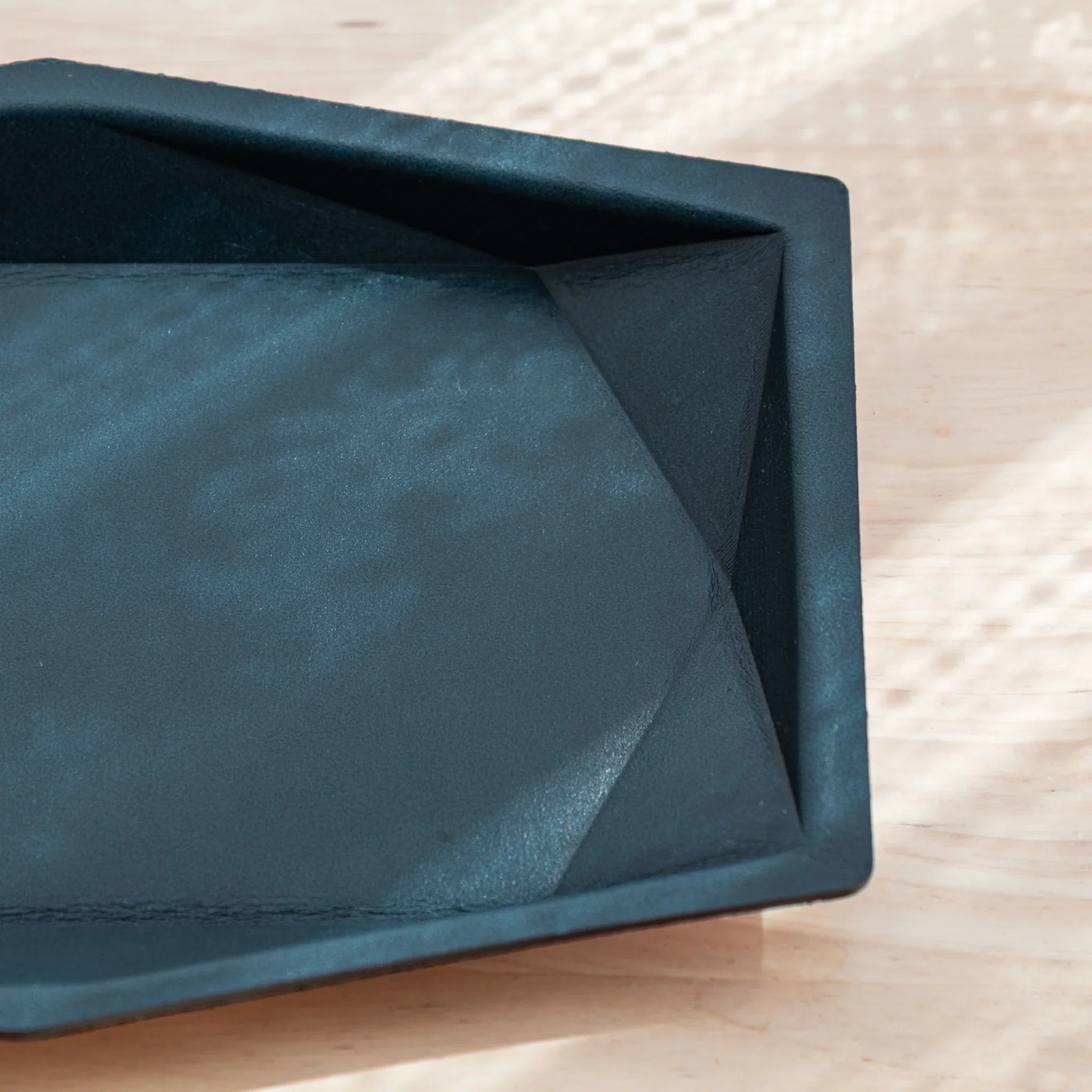Hexagonal leather pen tray from side profile showcasing distinctive hexagonal geometric form and leather construction