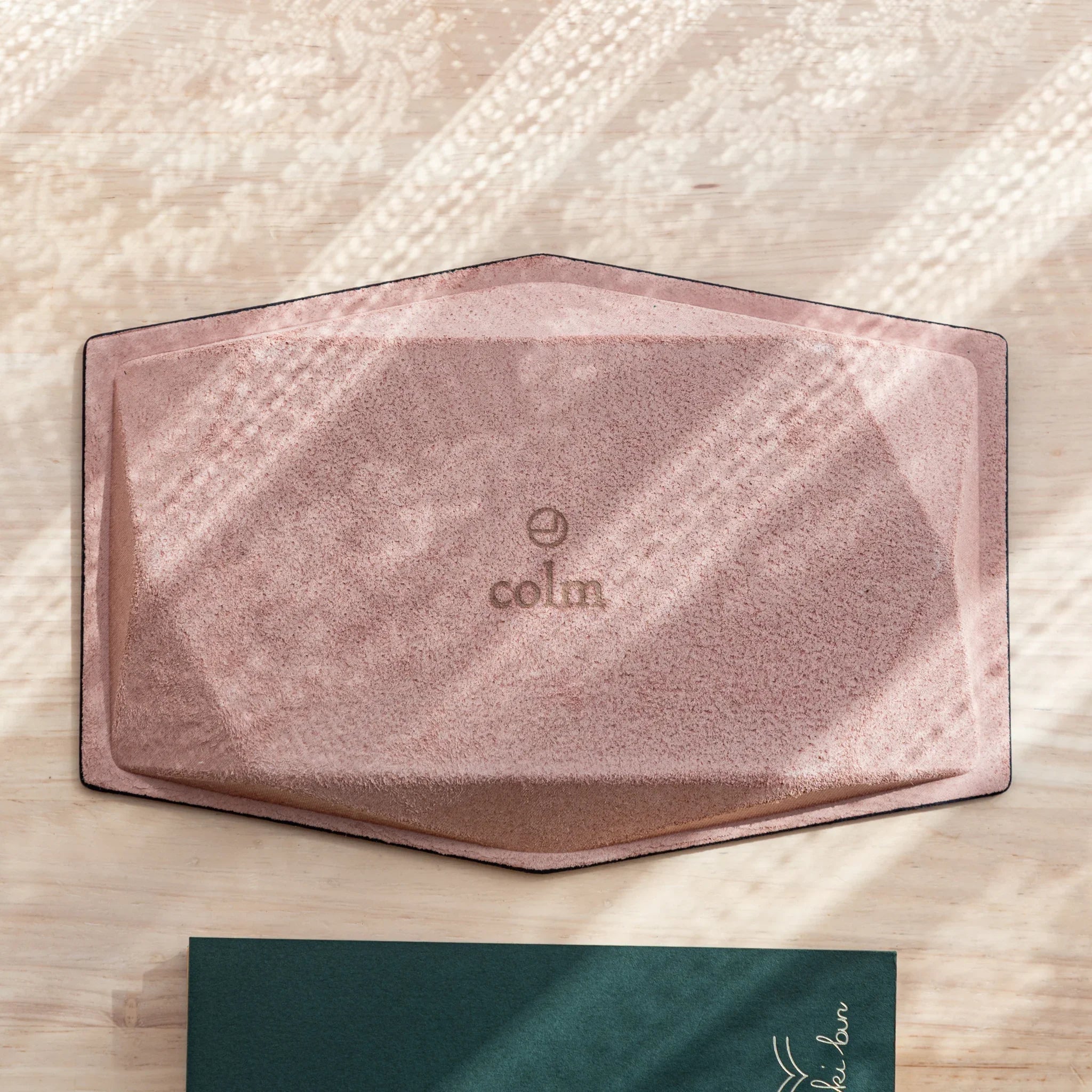 Back of the Japanese Pen Tray featuring pink suede and “colm” logo embossed in the center.
