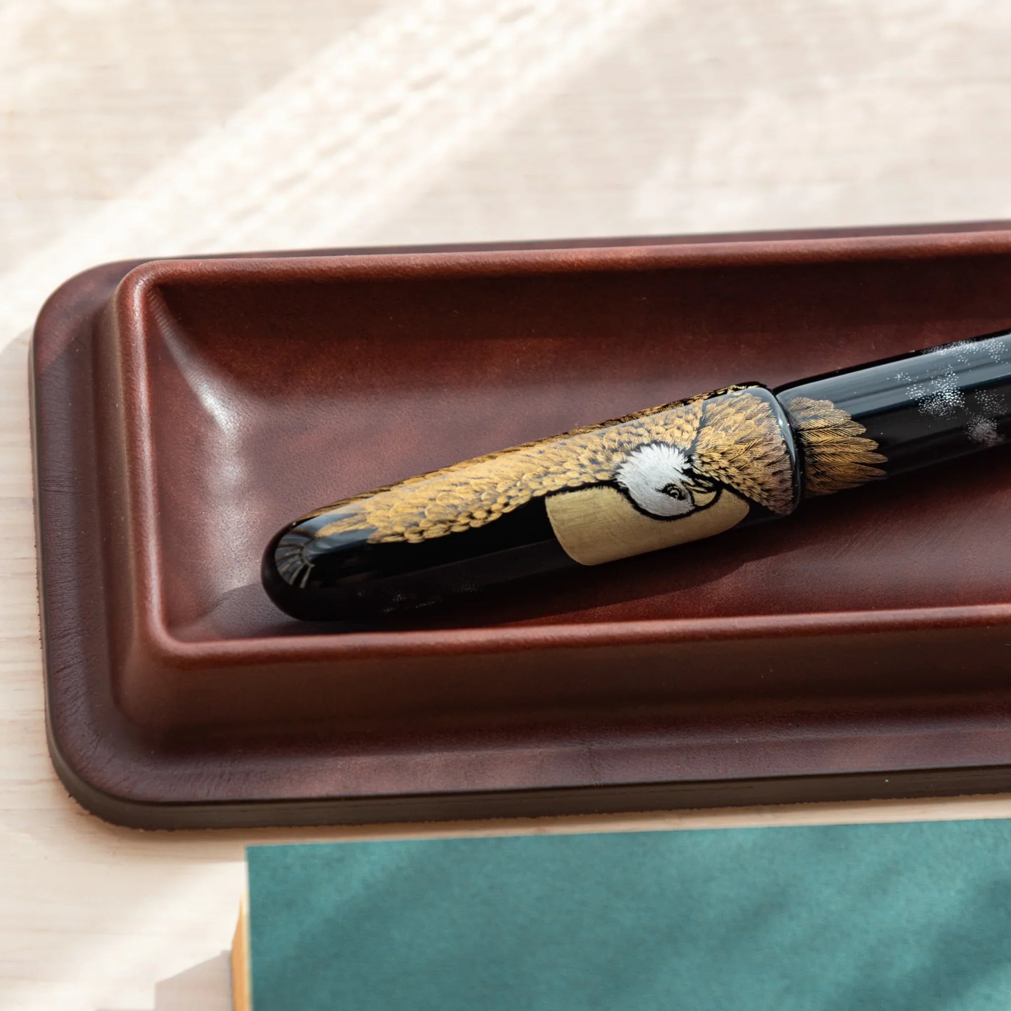 Japanese Fountain Pen with eagle design placed in brown Tatsuno Leather Pen Tray.