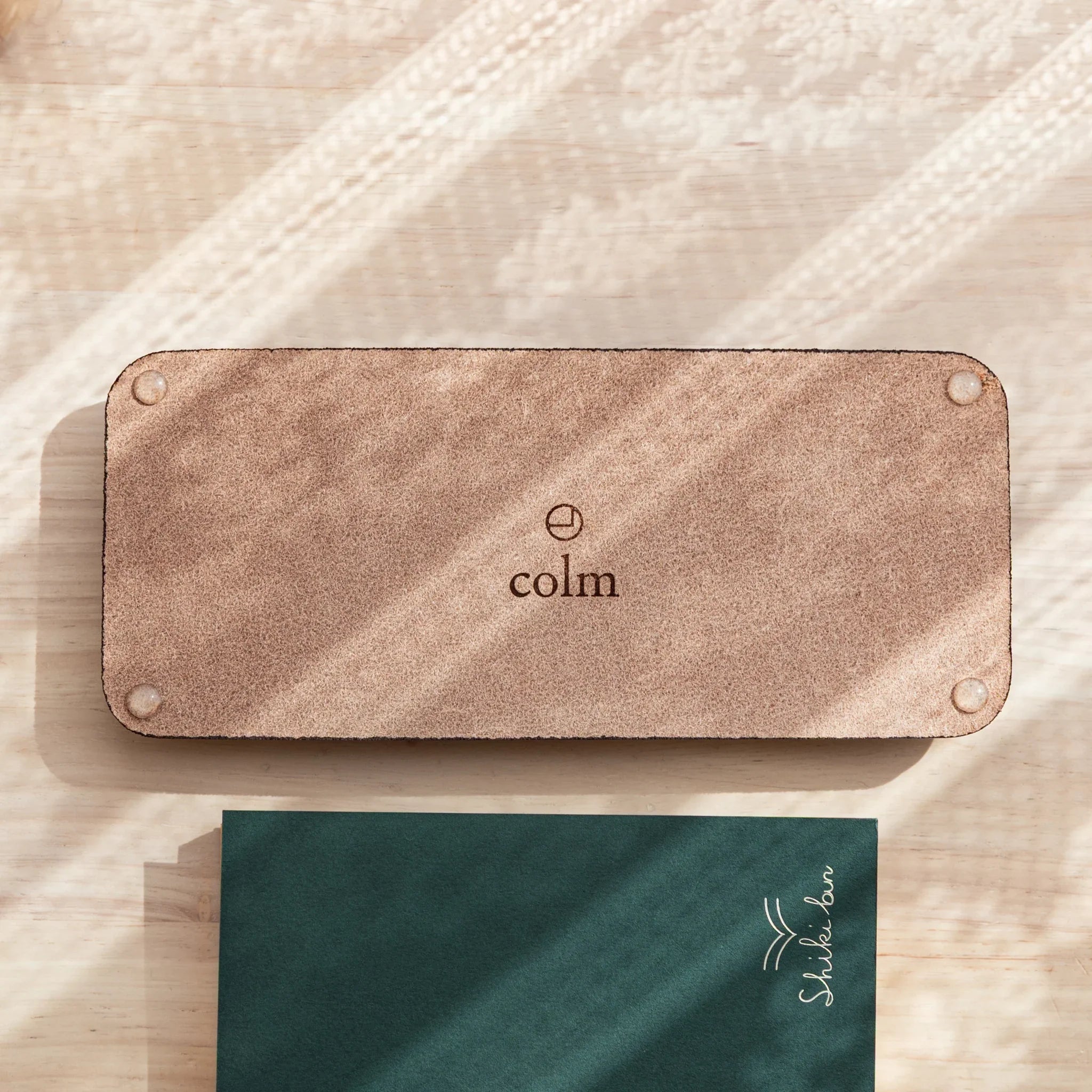 Back side of Tatsuno Leather Pen Tray showing suede texture and colm logo.