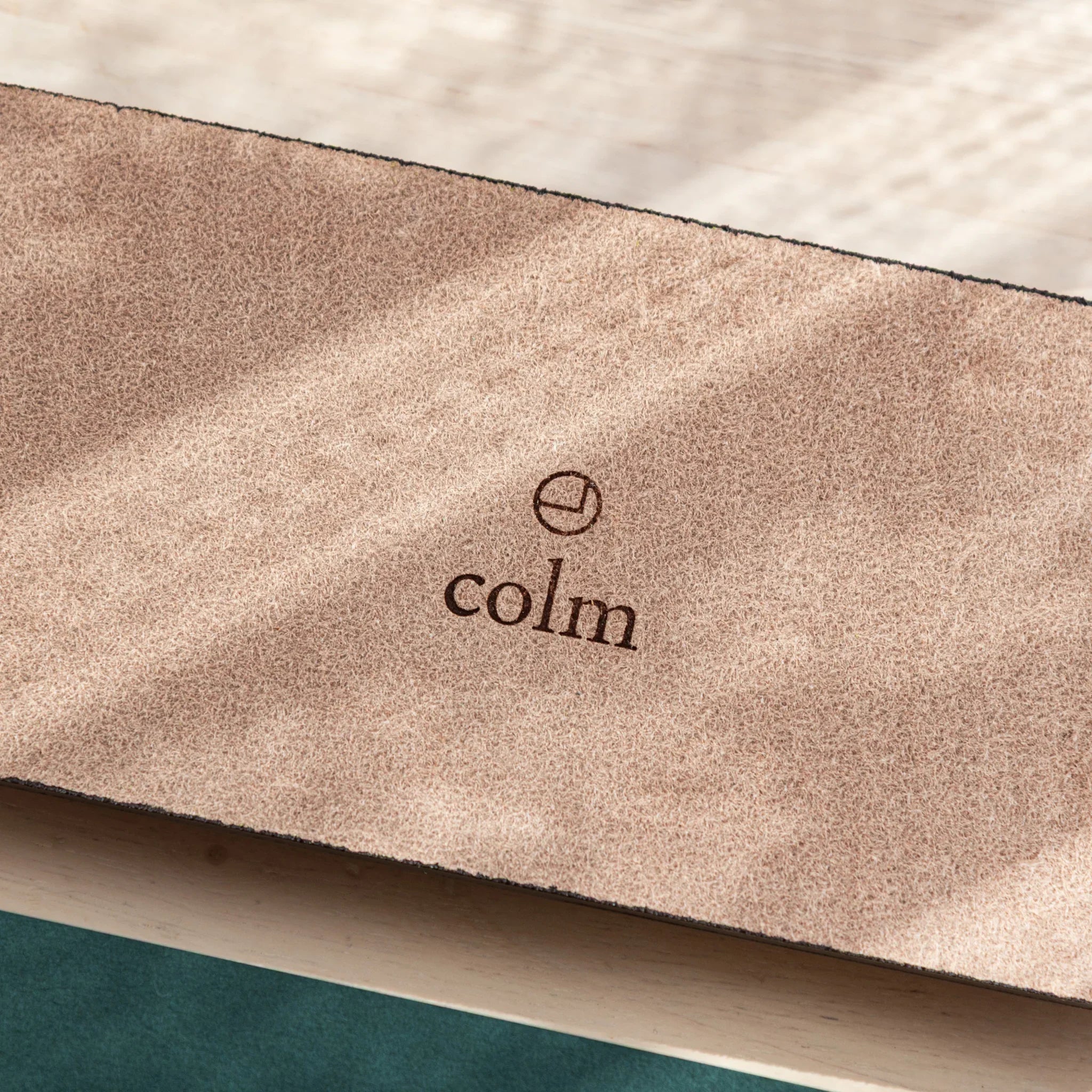 Zoomed-in view of colm logo on the suede back of Tatsuno Leather Pen Tray.