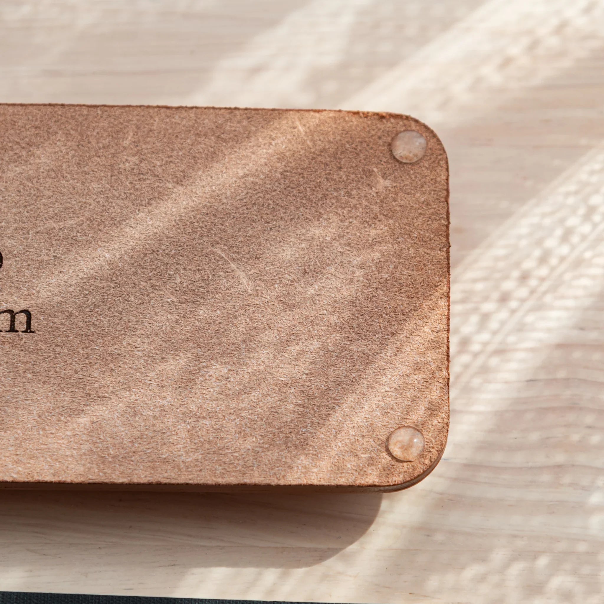 Bottom corner of Japanese pen tray featuring suede texture and anti-slip pads.