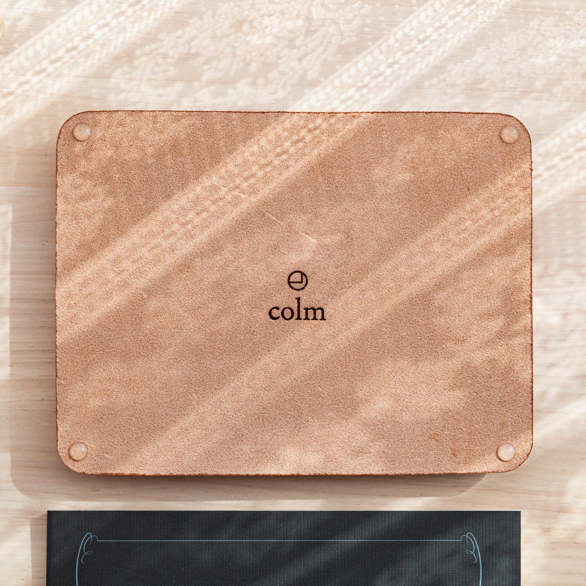 Wide leather pen tray from side profile displaying curved contoured rim and overall structured leather construction