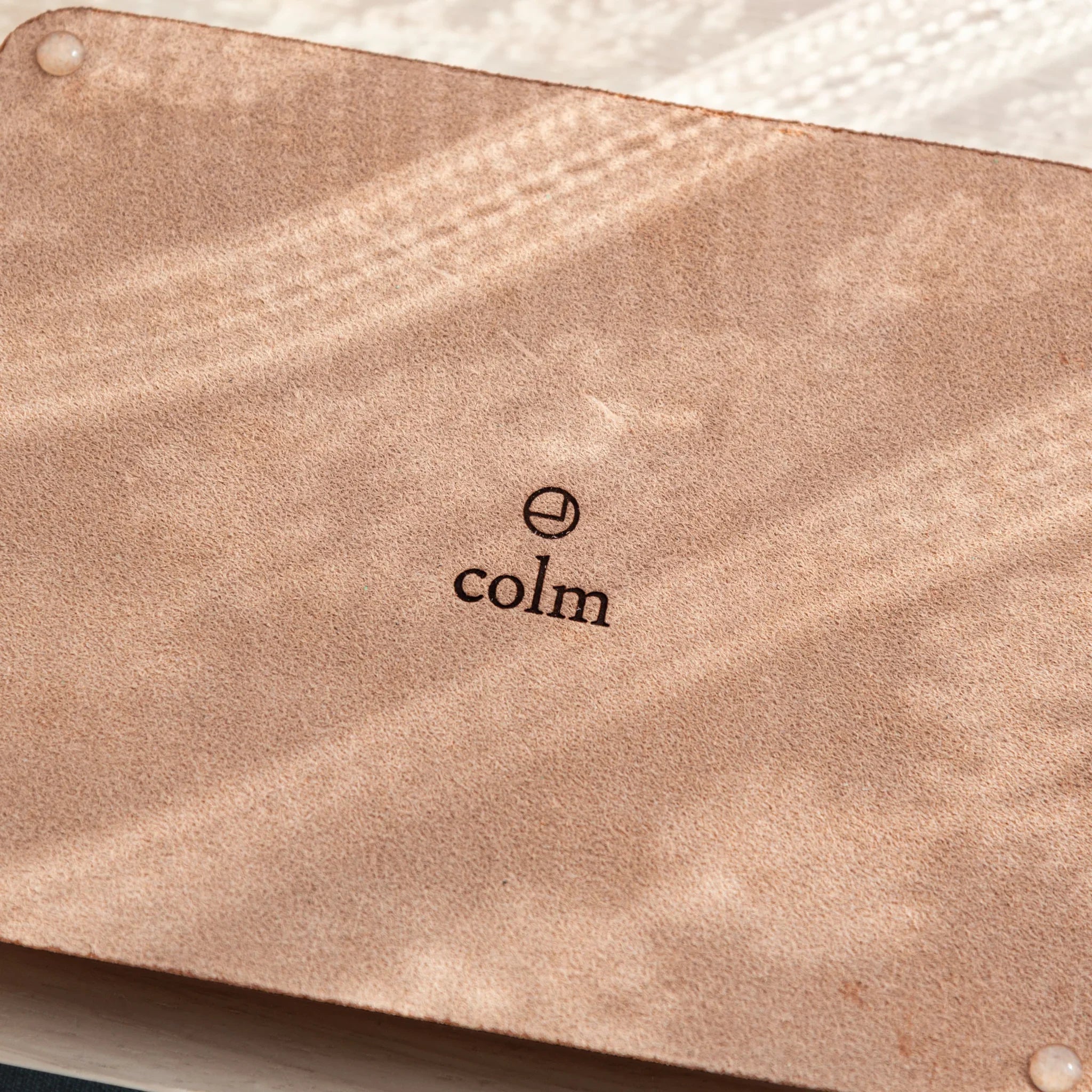 Suede back of Tatsuno Leather Pen Tray Wide with colm logo and rubber pads.