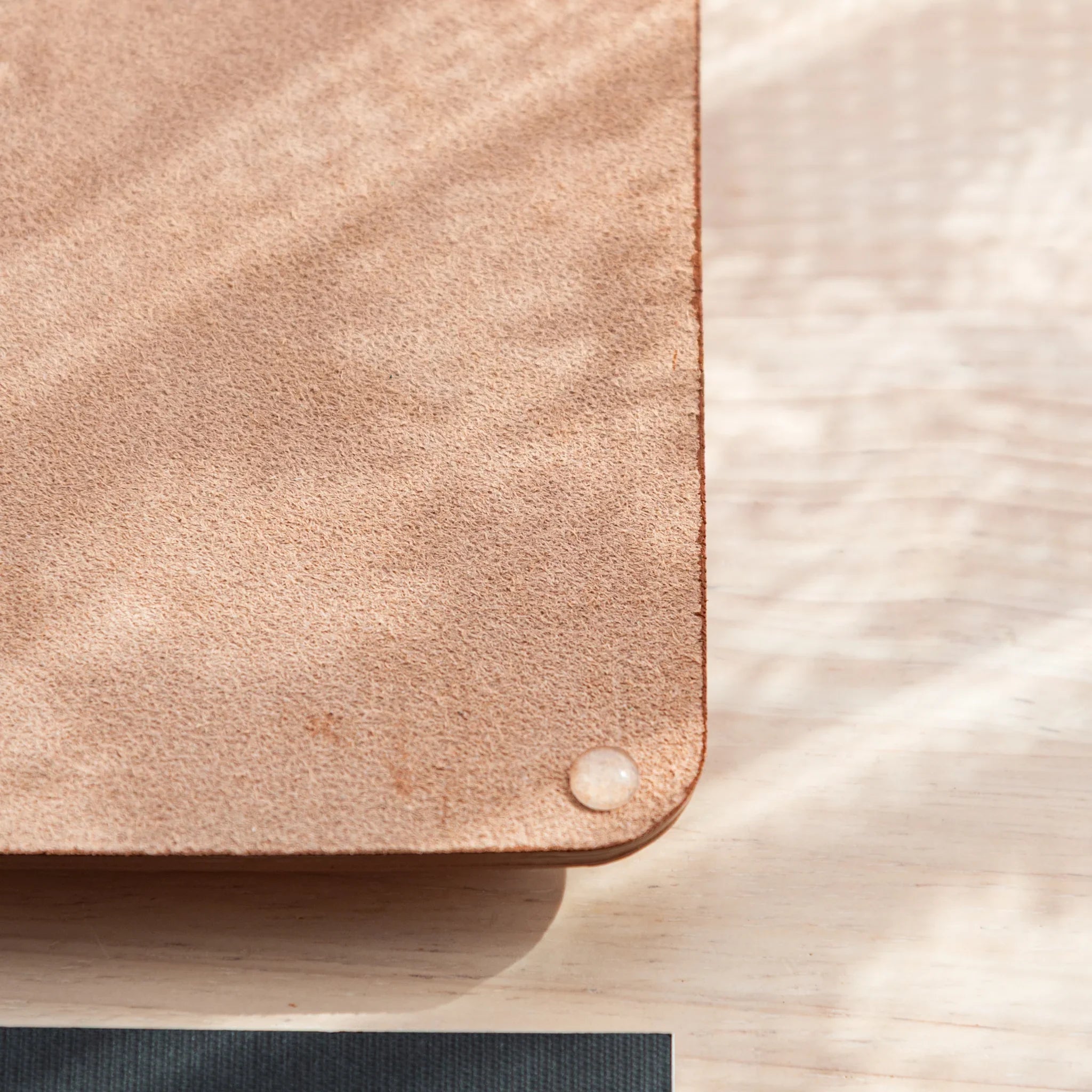 Corner of Japanese Pen Tray showing suede bottom and transparent anti-slip feet.