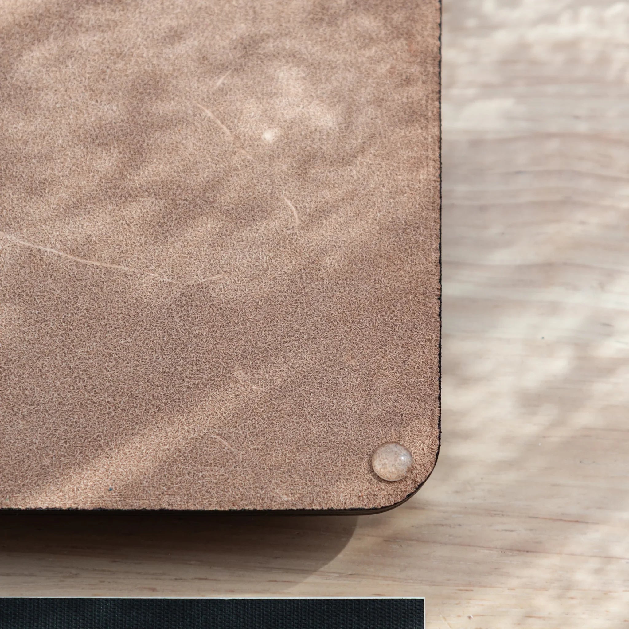 Black wide leather pen tray at angled perspective displaying the rectangular shape and interior storage capacity view
