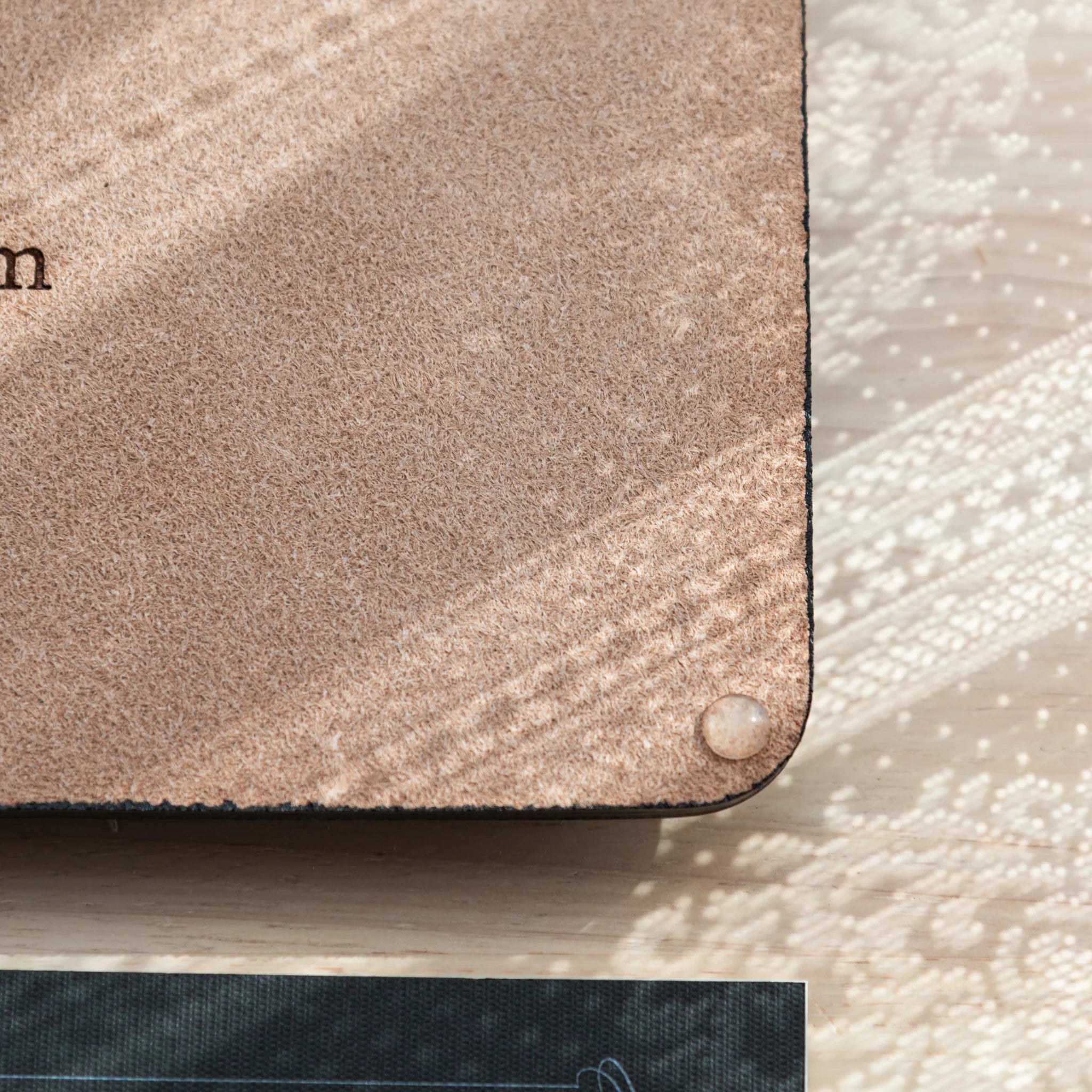 Detail of anti-slip rubber pads on bottom of Tatsuno Leather Pen Tray Wide.