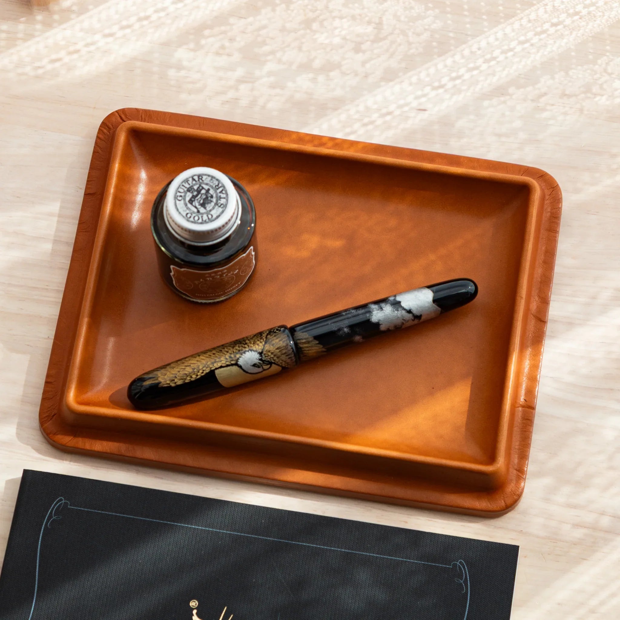 Japanese Pen Tray in camel leather, shown with ink bottle and Japanese fountain pen.