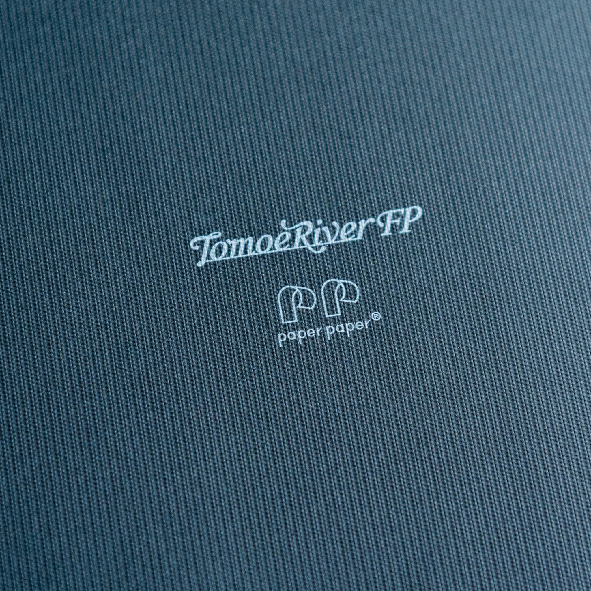 Sanzen Tomoe River notebook flat composition showing soft cover construction and paper thickness detail