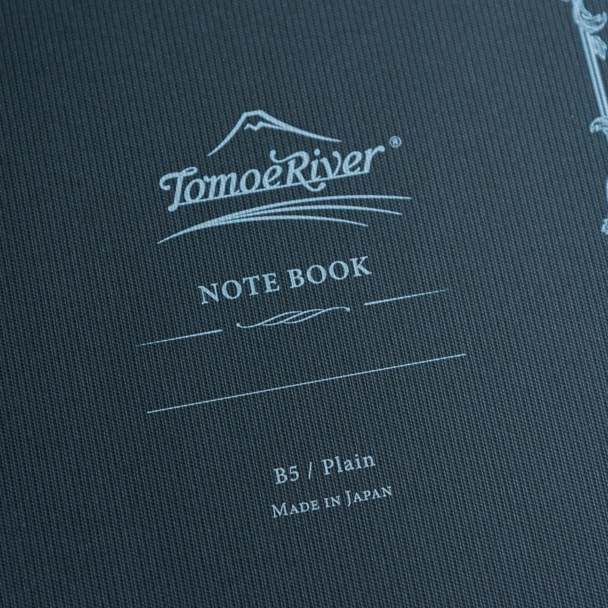 Sanzen Tomoe River notebook opened showing fountain pen friendly paper pages and soft cover construction