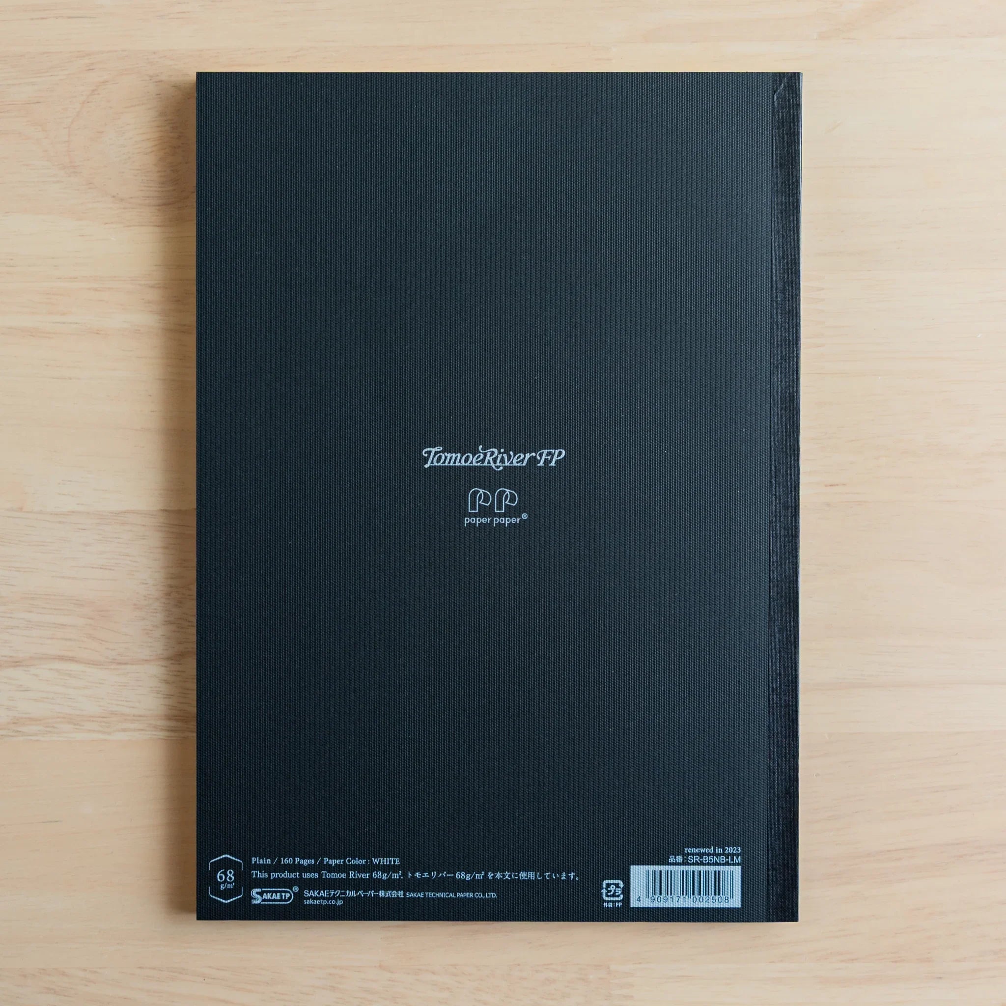 Tomoe River FP notebook detail spread showing light page markings and Japanese paper quality, Japanese notebook