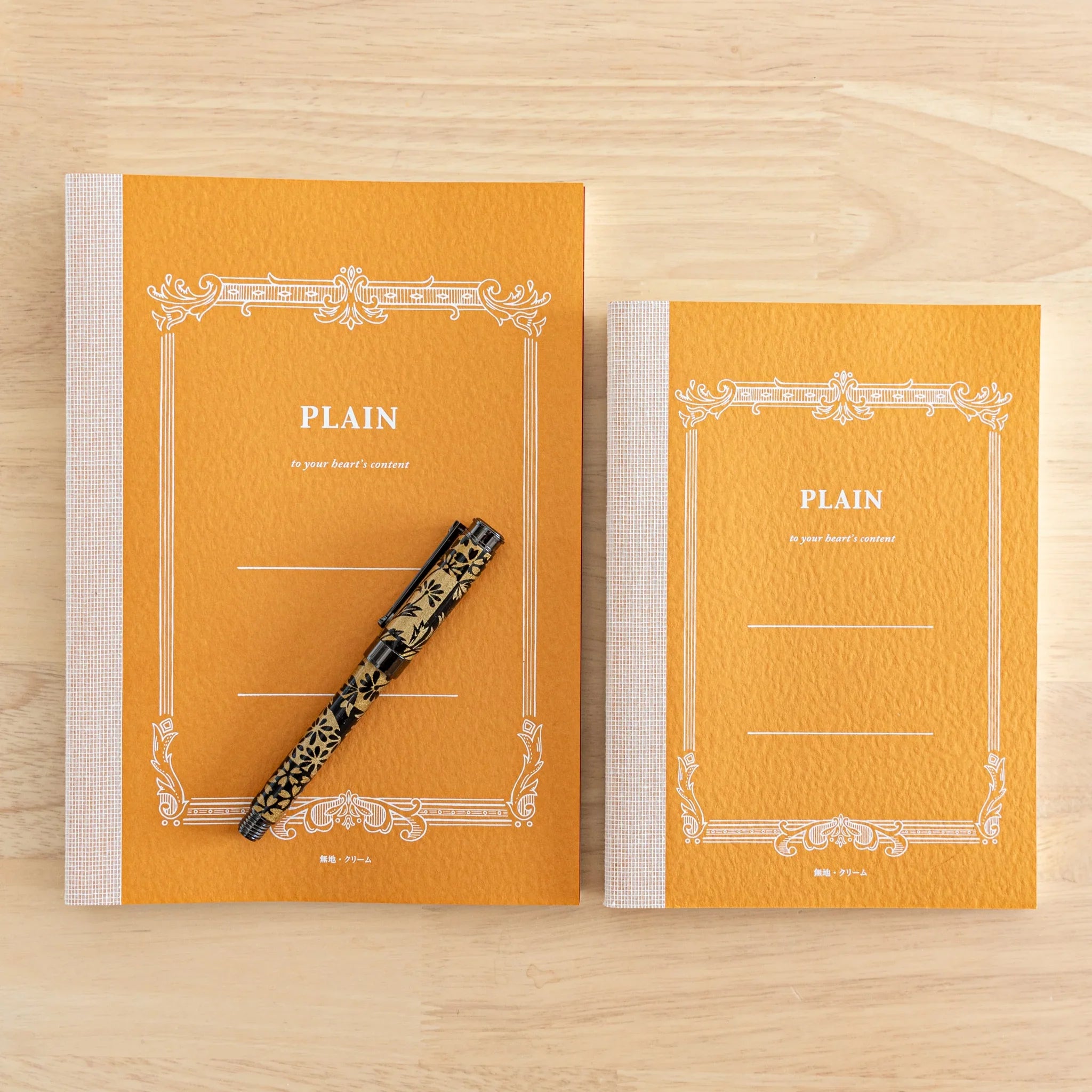 Tsubame Fools Cream Notebook front cover close-up, white embossed title on cream-colored textured Japanese stationery