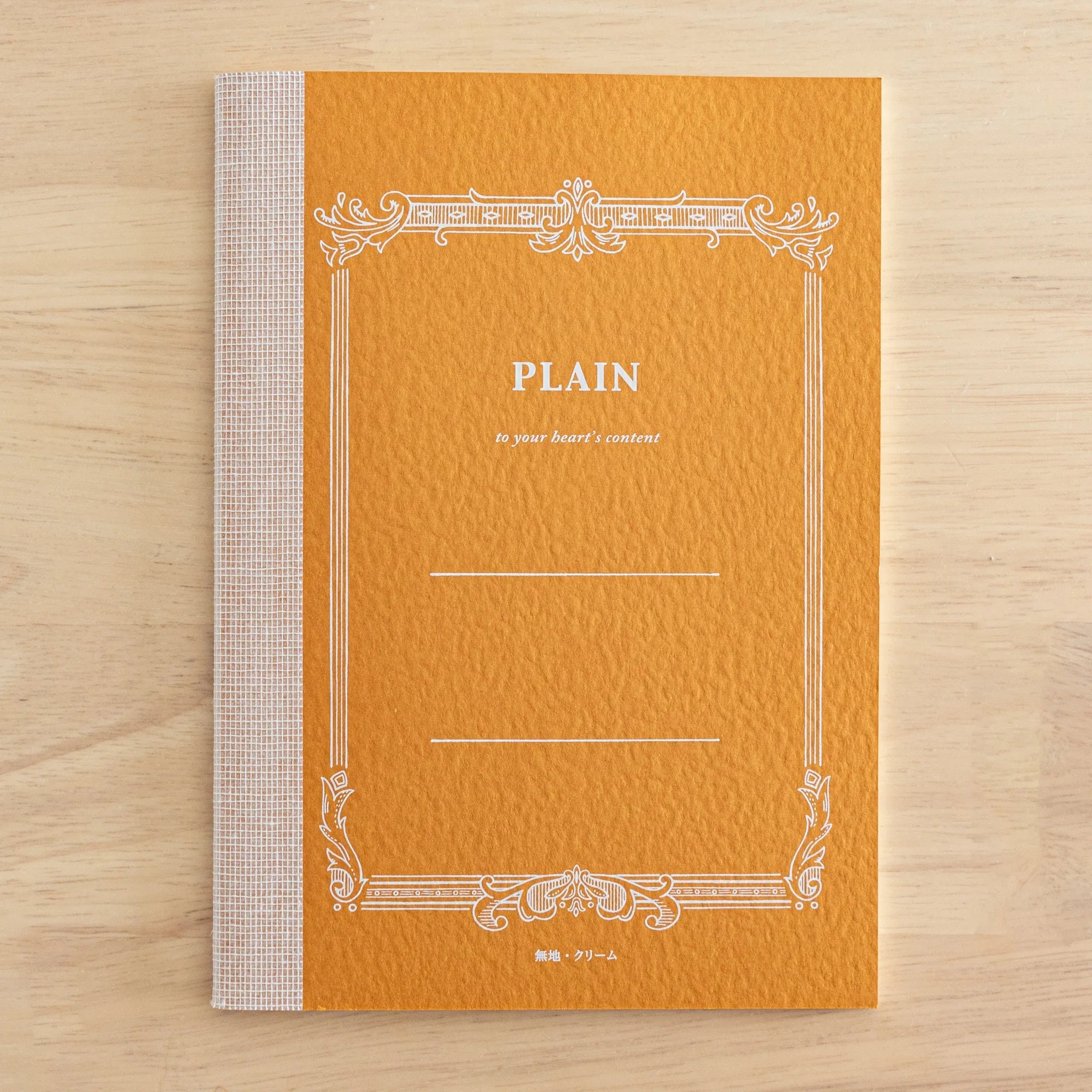 Tsubame Fools Cream Notebook cover shot with light cream surface, subtle branding, refined binding and page edges