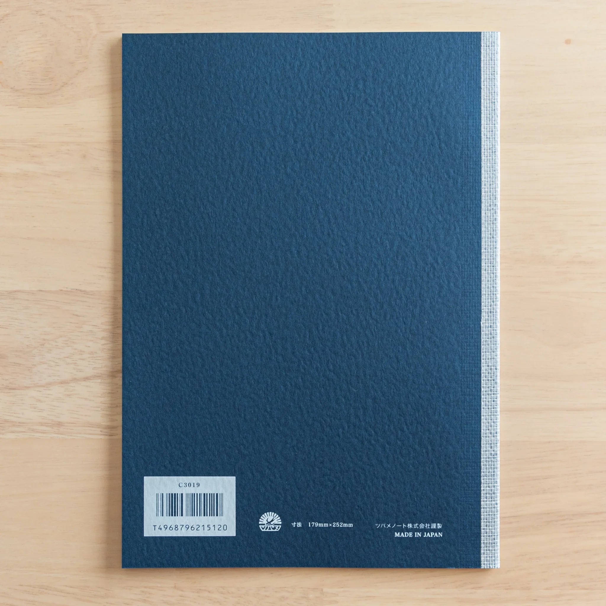 Tsubame Fools Cream Notebook open with interior pages visible showing grid pattern throughout cream paper