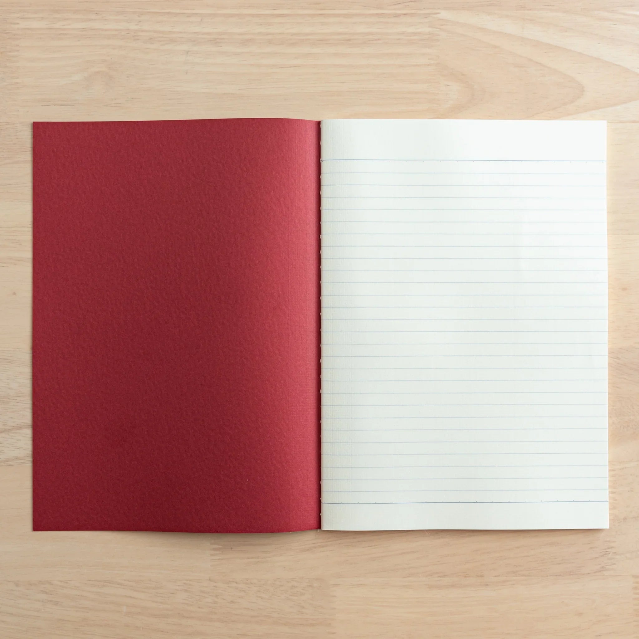 Tsubame Fools Cream Notebook with red fabric cover and open spread showing white ruled pages Japanese stationery
