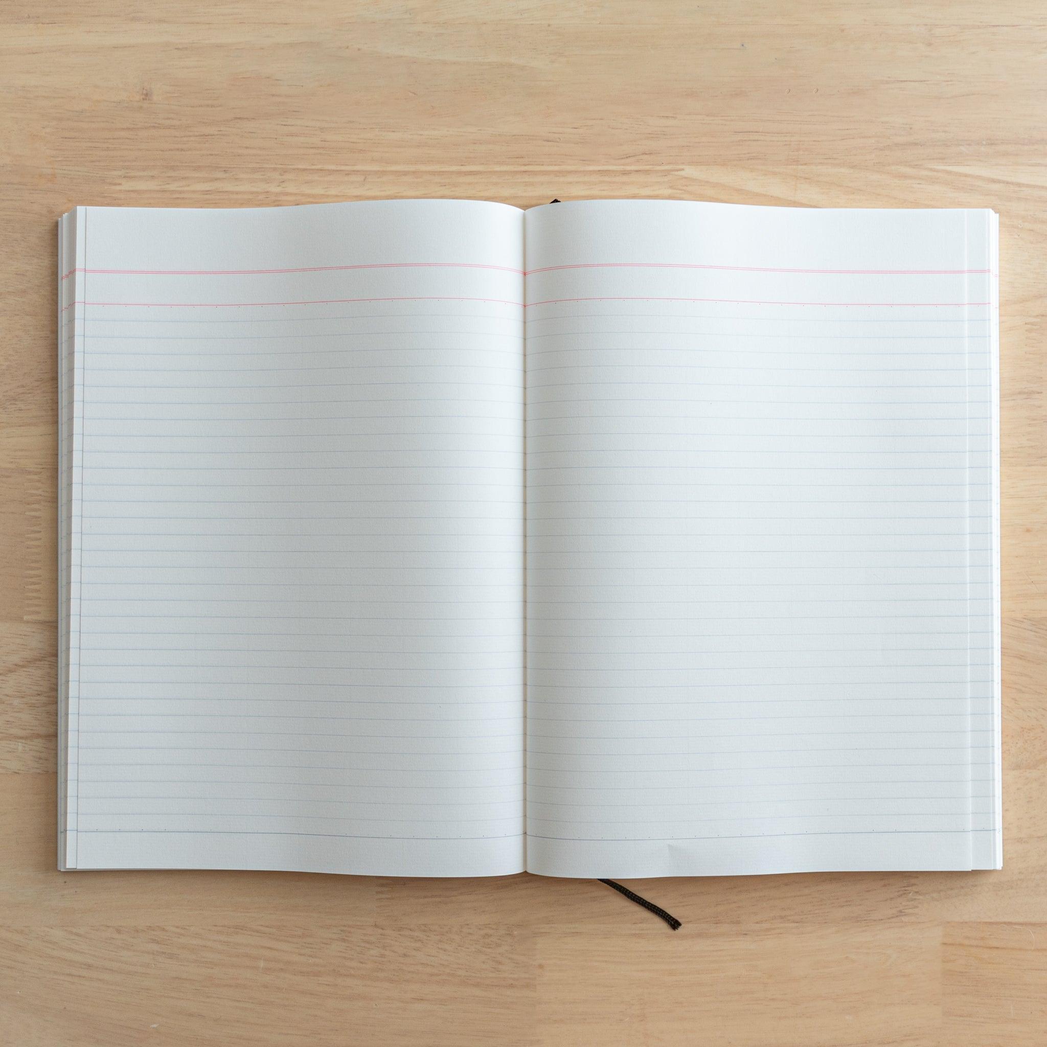 A fully opened Japanese notebook displaying two lined pages with subtle blue margins, crafted with high-quality paper and elegant Japanese stationery design.