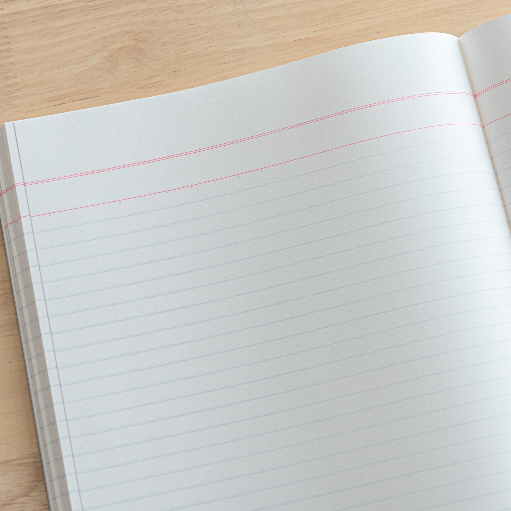 A fully opened Japanese notebook displaying two lined pages with subtle blue margins, crafted with high-quality paper and elegant Japanese stationery design.