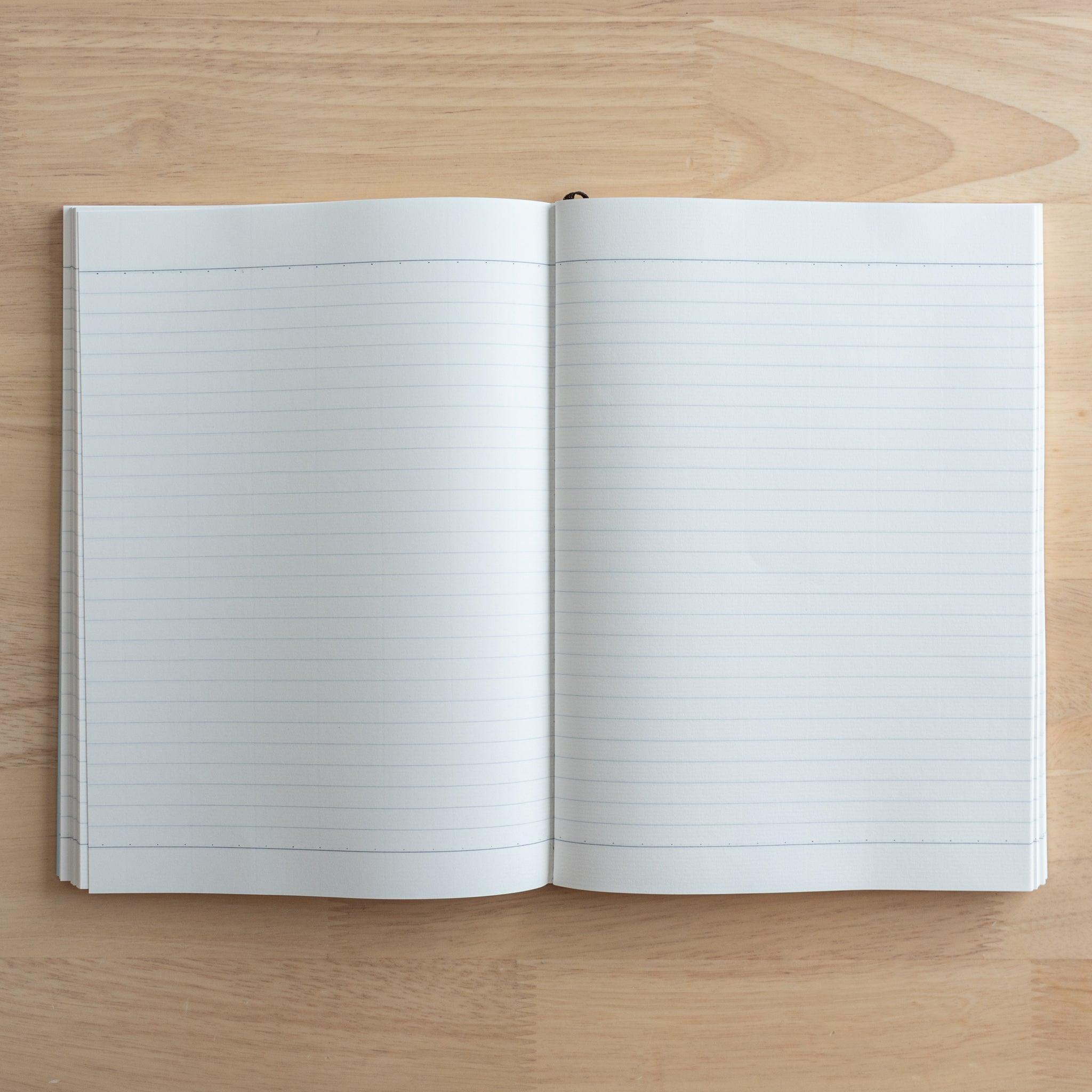 A fully opened Japanese notebook displaying two lined pages with subtle blue margins, crafted with high-quality paper and elegant Japanese stationery design.