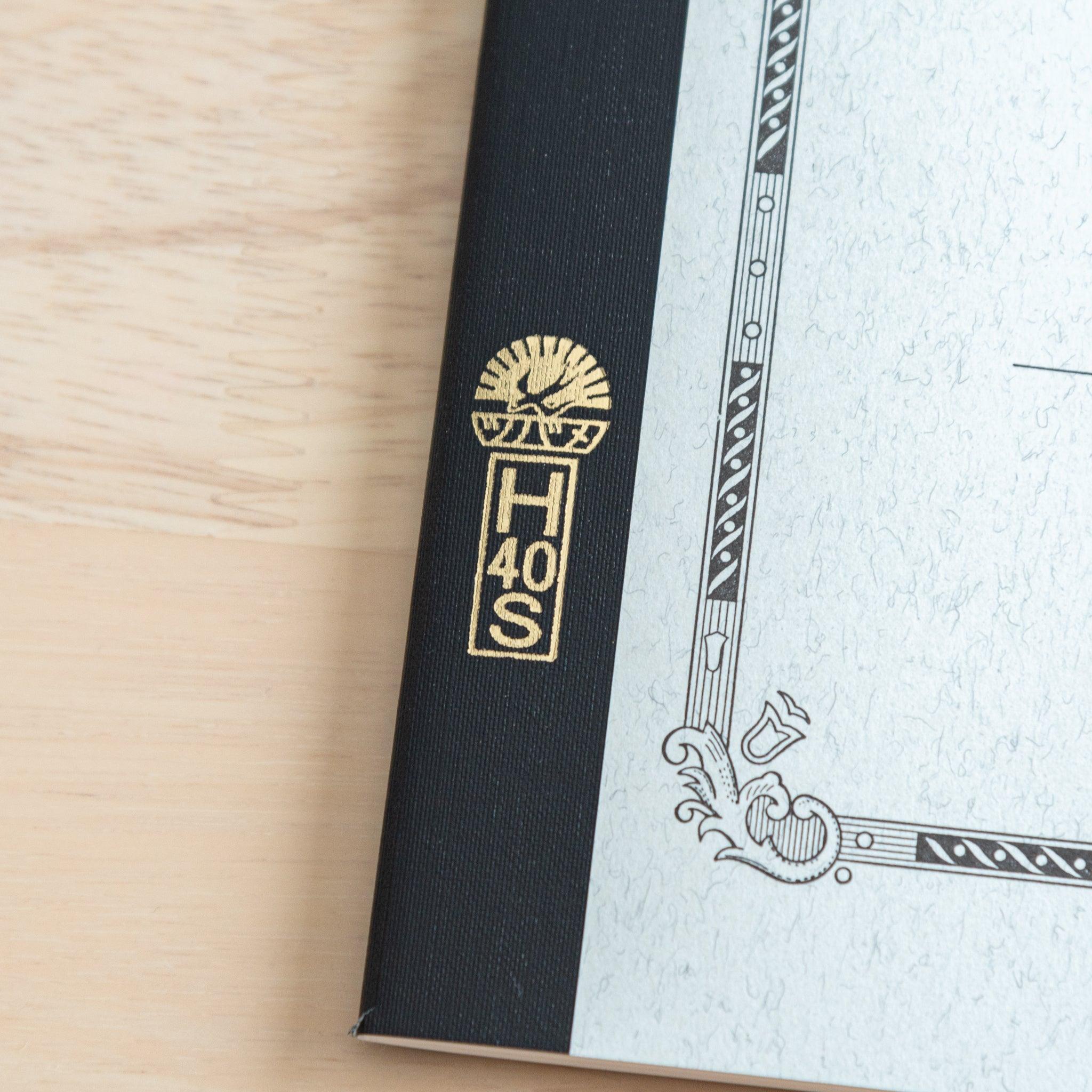 A close-up of the Tsubame Japanese notebook’s spine with gold lettering and the brand’s iconic logo, highlighting its premium Japanese stationery craftsmanship.