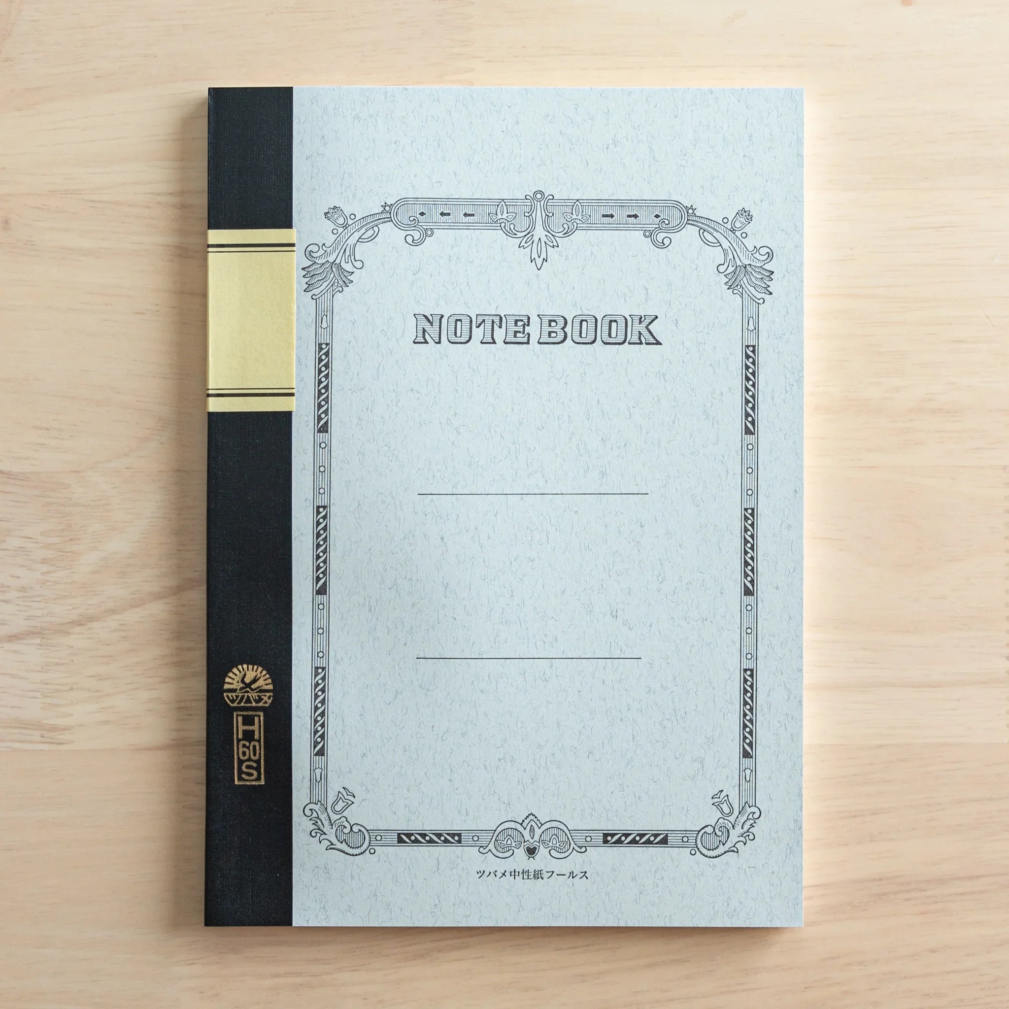 Japanese college notebook front cover with decorative border, 'NOTEBOOK' text on cream paper with black spine