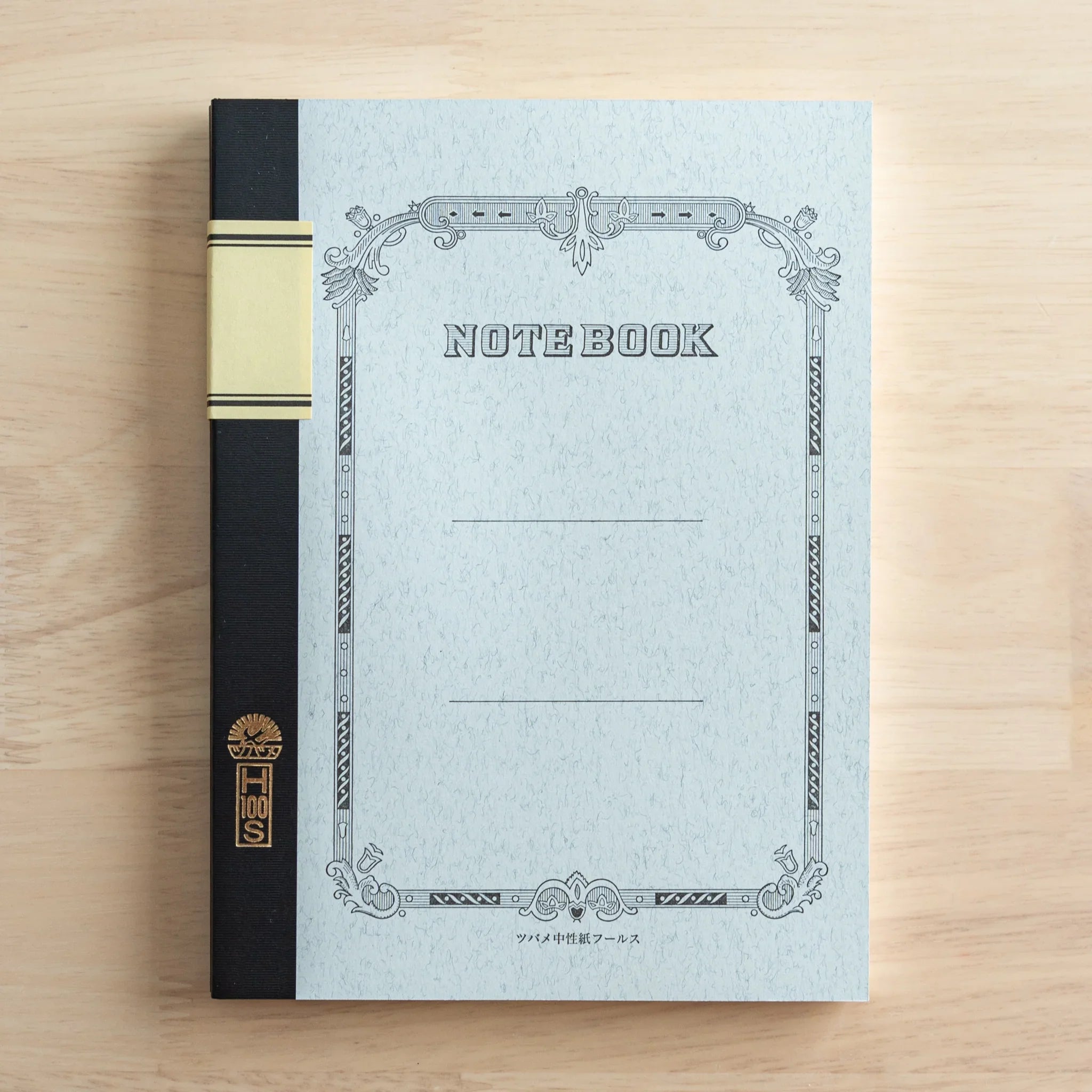 Back cover view of Tsubame Fools University Notebook with matching decorative frame border on cream paper