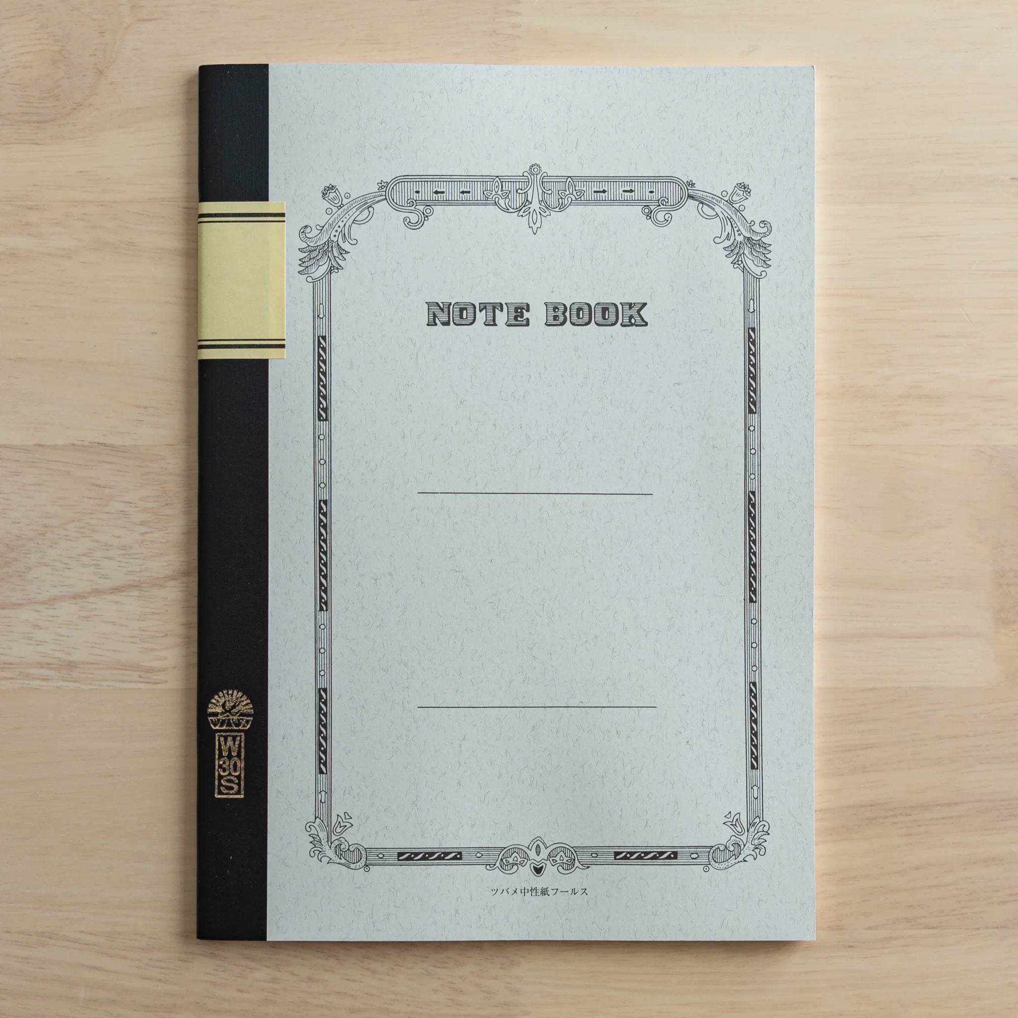 Open spread of Tsubame Fools University Notebook displaying ruled cream pages with consistent line pattern