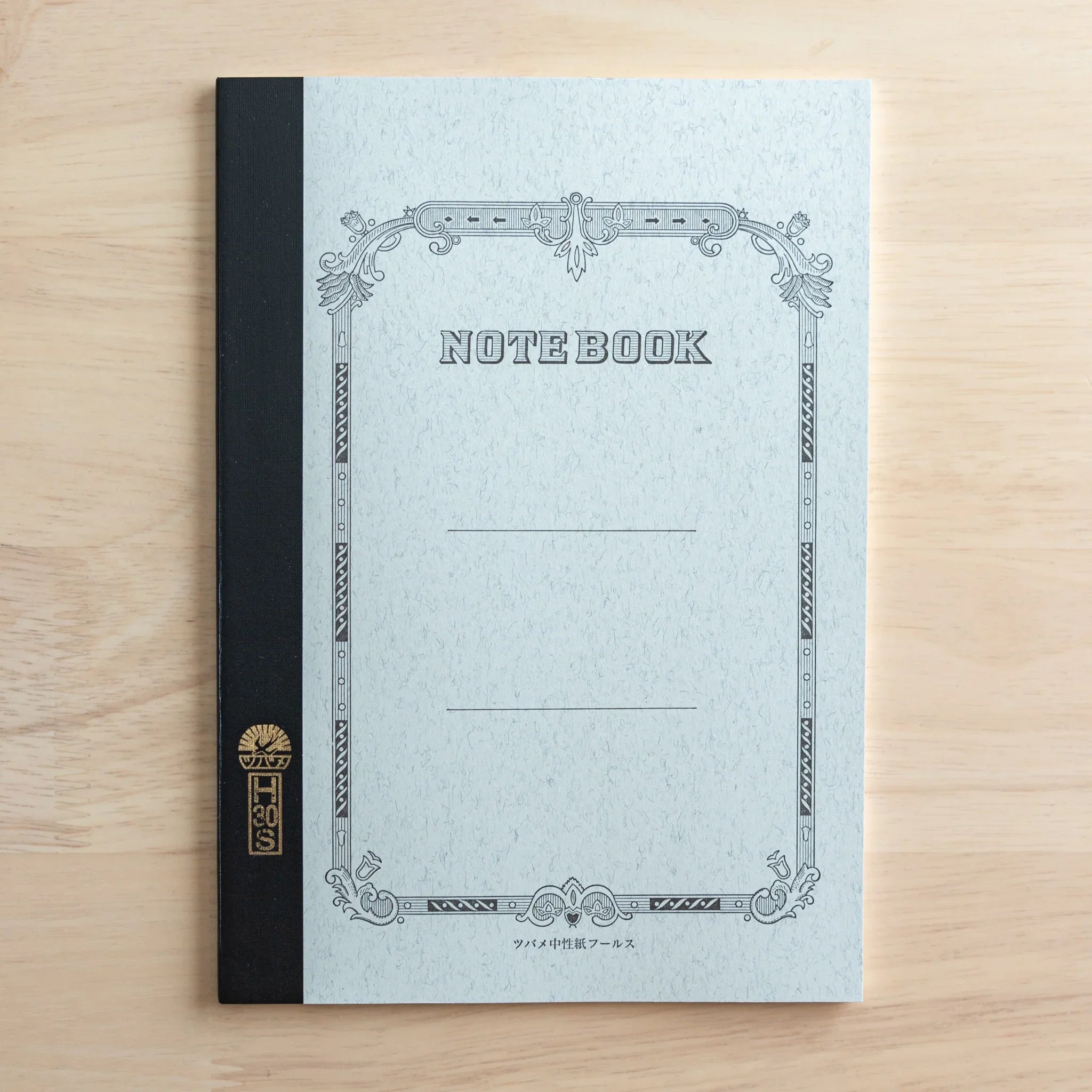 Tsubame Fools University Notebook open spread showing cream-colored fine ruled pages format visible flat lay
