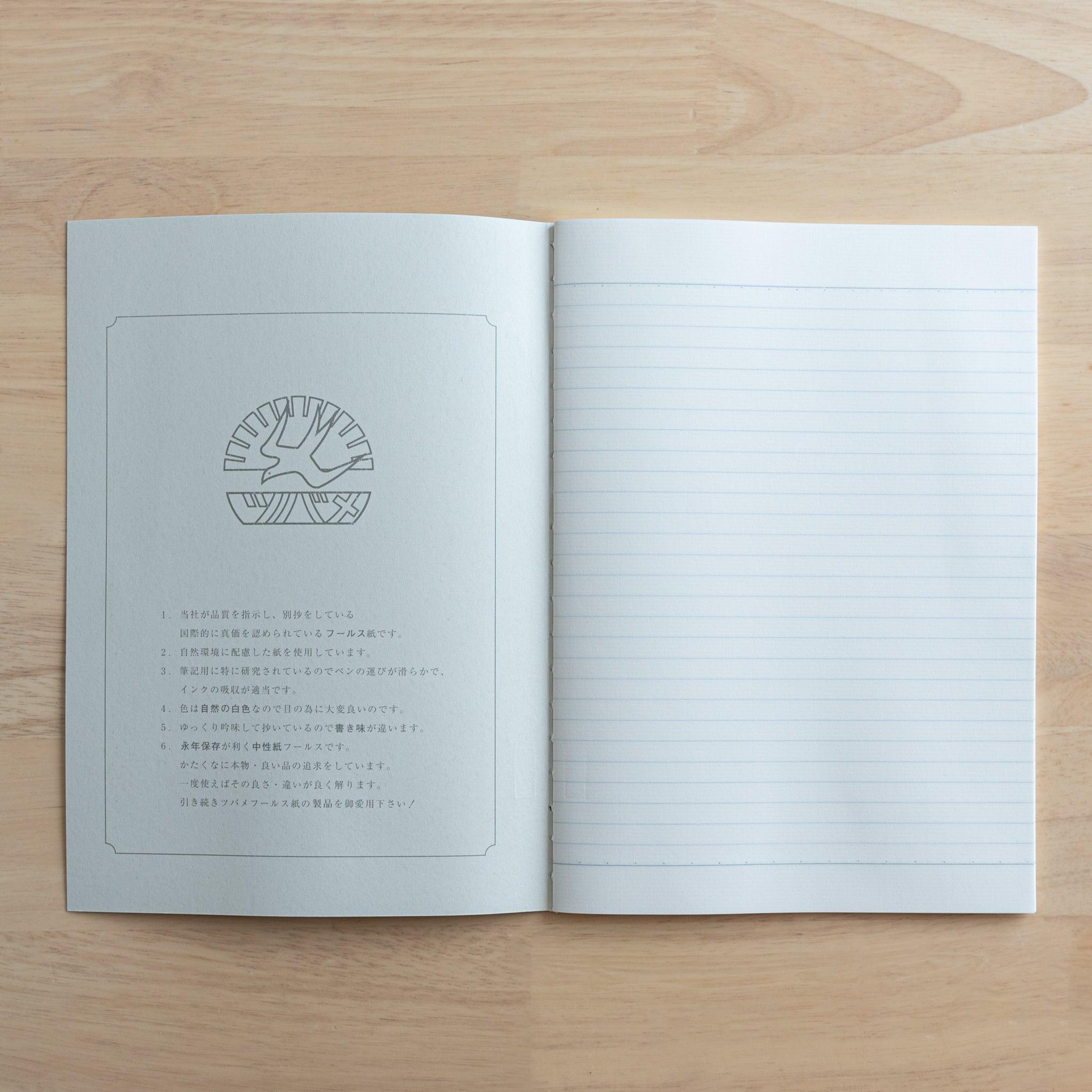 An open Tsubame Japanese notebook displaying a logo and product details on the left page and fine-quality lined paper on the right, showcasing premium Japanese stationery.