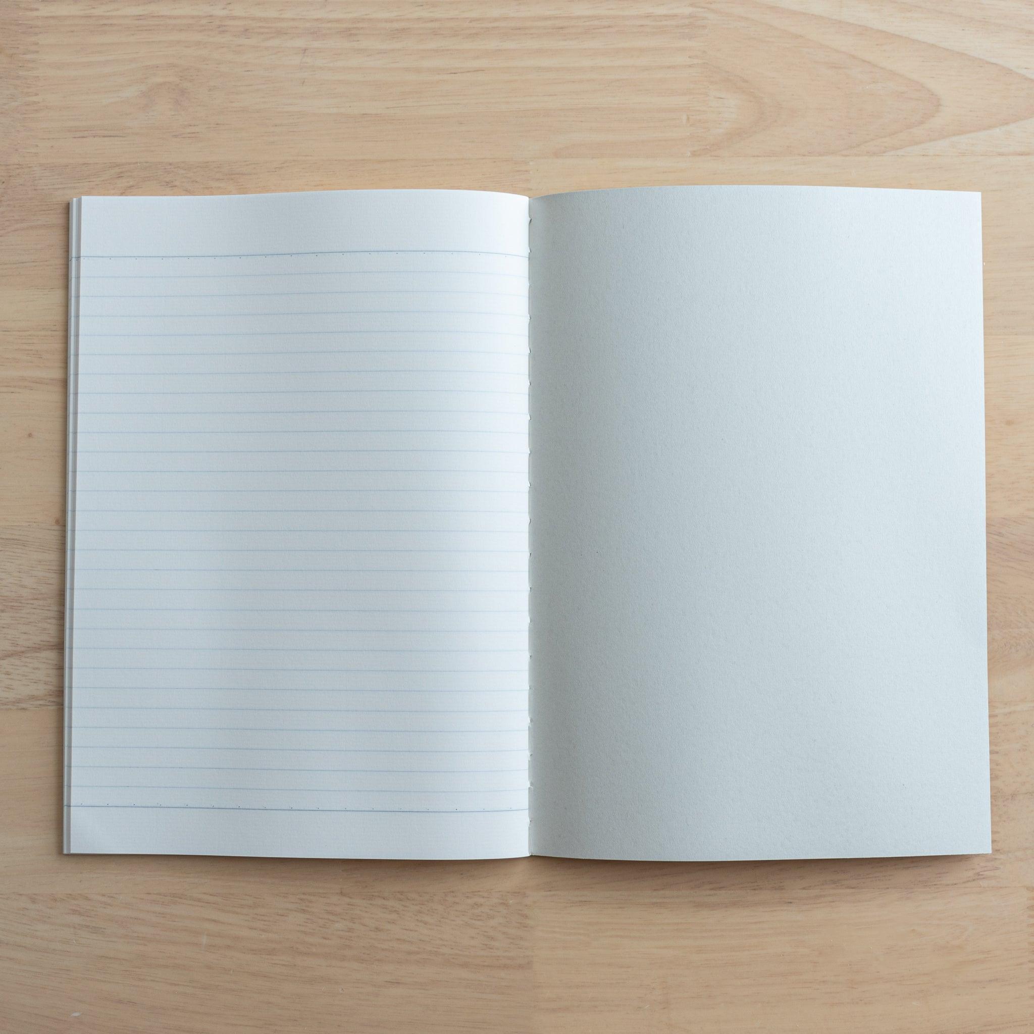 An open Tsubame Japanese notebook showing a lined page on the left and a blank inner cover on the right, crafted with high-quality Japanese stationery design.