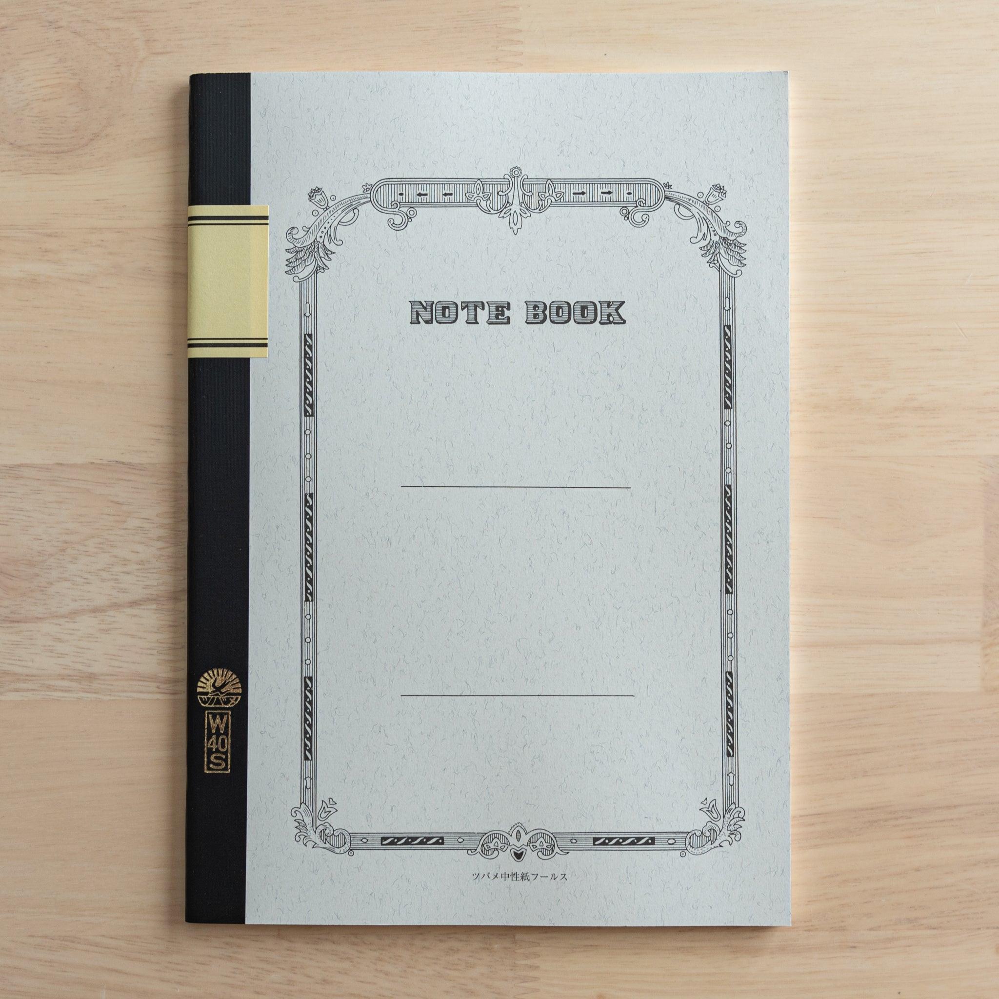 A Tsubame Japanese notebook with a decorative cover, black spine, and a gold label, showcasing the elegant and classic design of high-quality Japanese stationery.