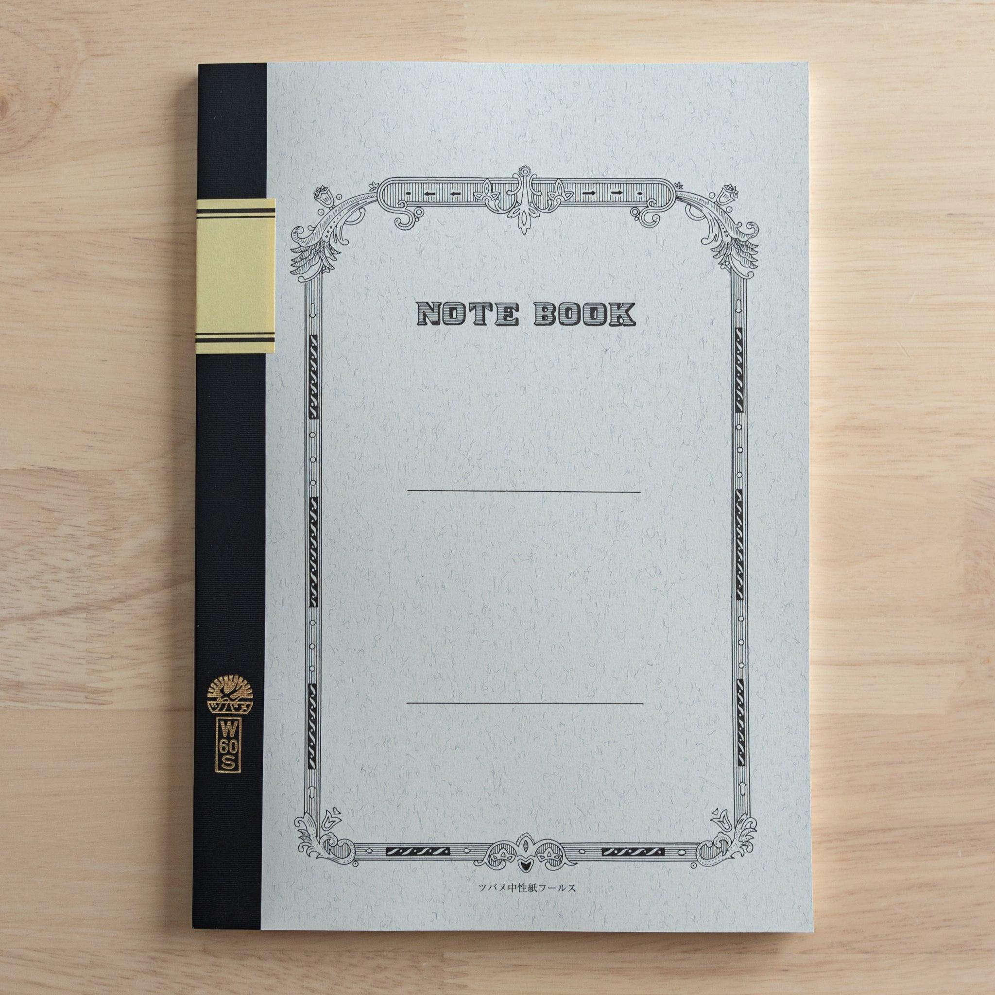 A Tsubame Japanese notebook with a decorative cover, black spine, and a gold label, showcasing the elegant and classic design of high-quality Japanese stationery.