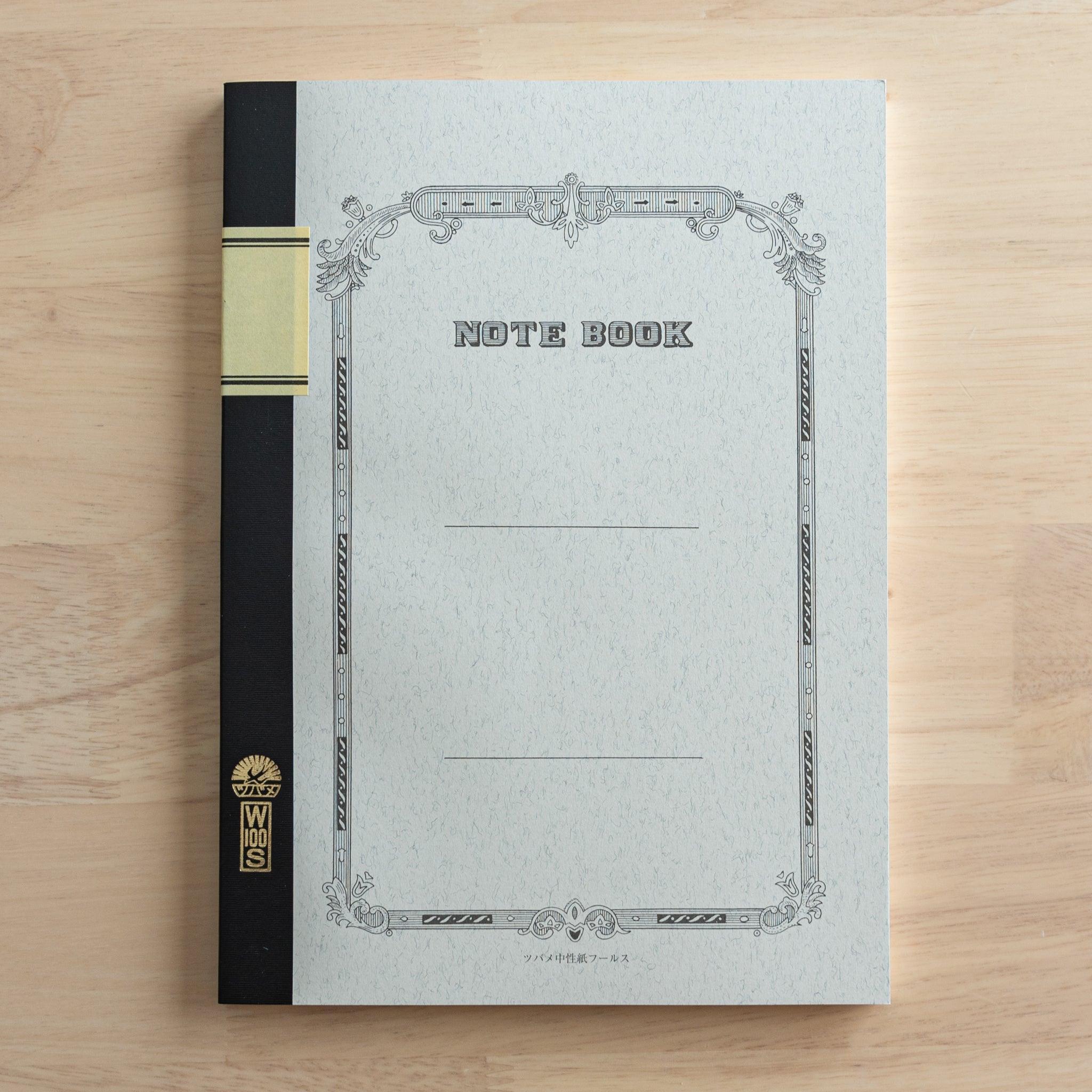 A Tsubame Japanese notebook with a decorative cover, black spine, and a gold label, showcasing the elegant and classic design of high-quality Japanese stationery.