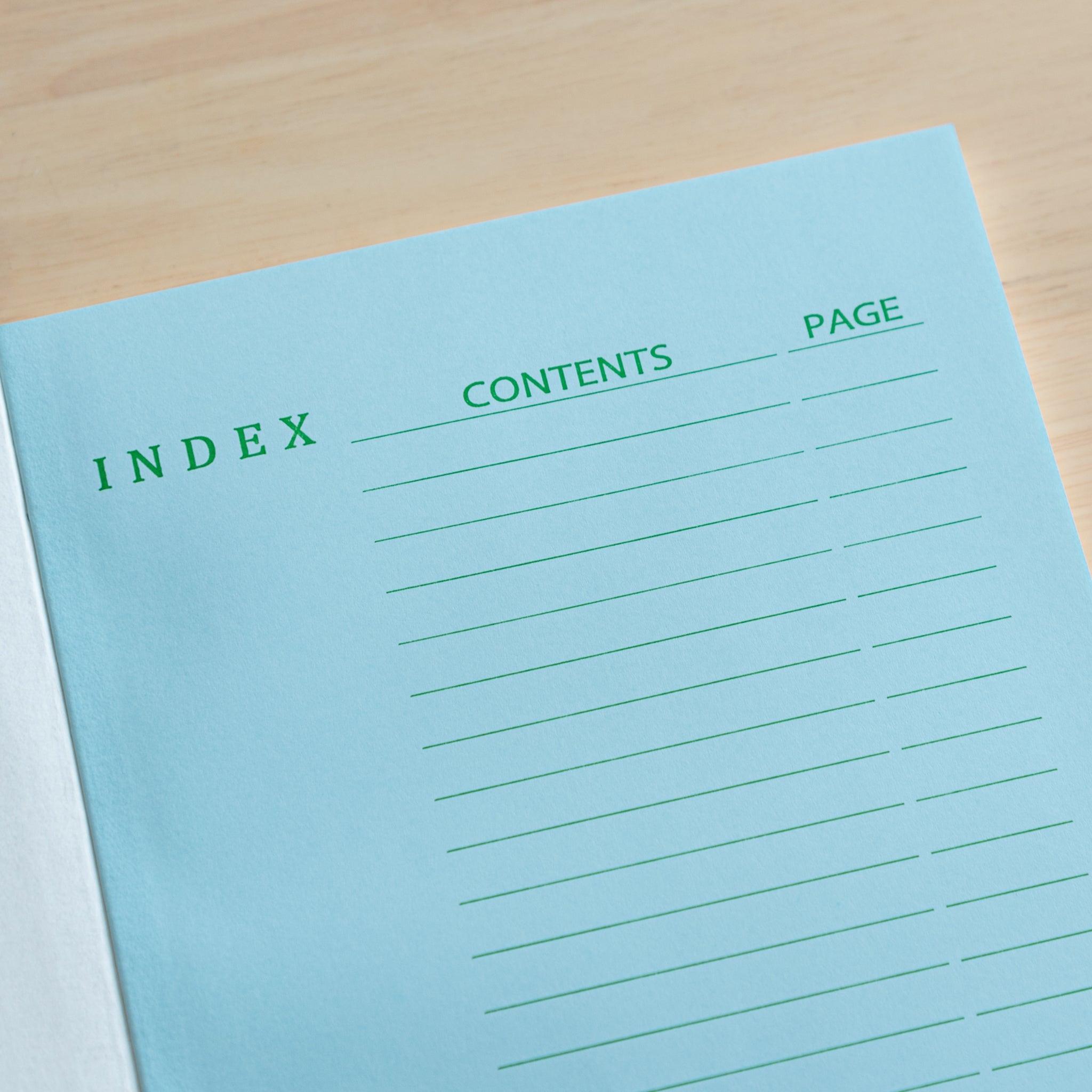 A close-up of the Tsubame Japanese notebook’s blue index page with green headings and lines, designed for organizing content, highlighting premium Japanese stationery.