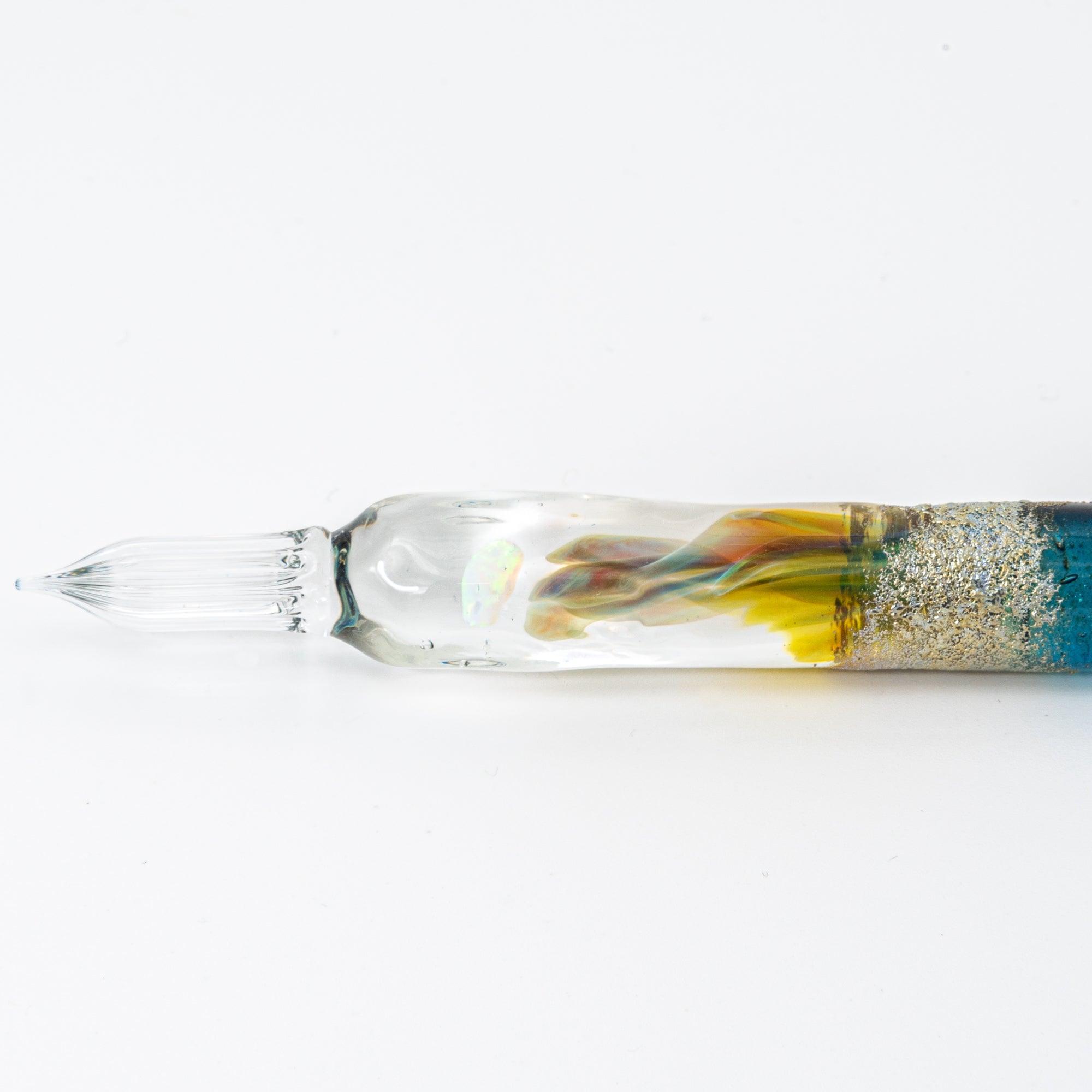 Elegant glass pen with a suspended opal and silver accents, featuring a gradient from blue to clear. Perfect for luxury writing experiences.
