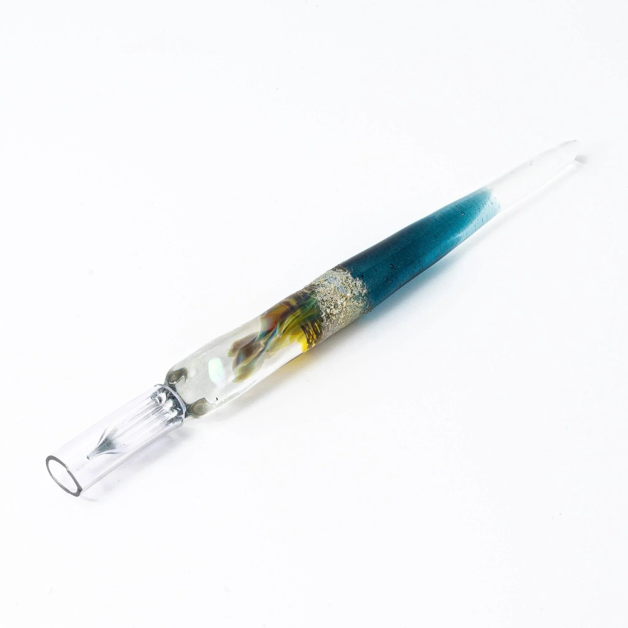 Deep blue glass dip pen designed for calligraphy work showing fine precision nib and transparent barrel with holder