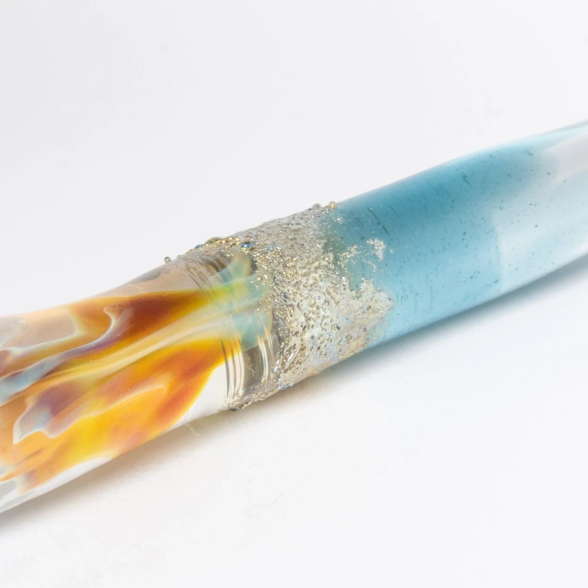 Fine detail close-up of light blue Tsukuyomi glass dip pen nib showing precision engineering and artistry shine