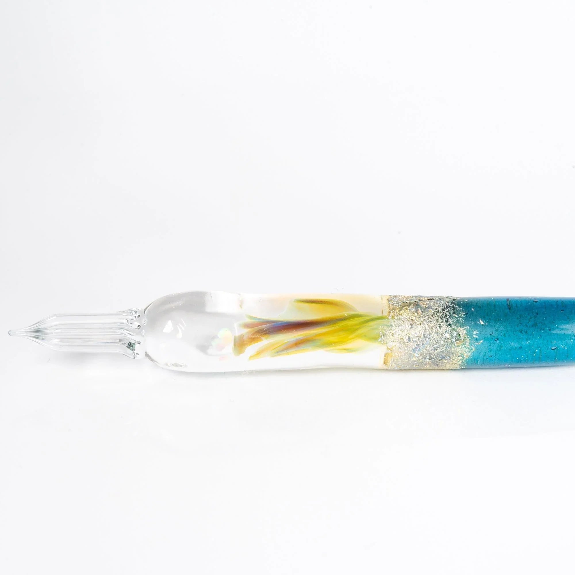 Light blue glass dip pen angled view highlighting moon goddess design inspirations in artistic nib detail shine