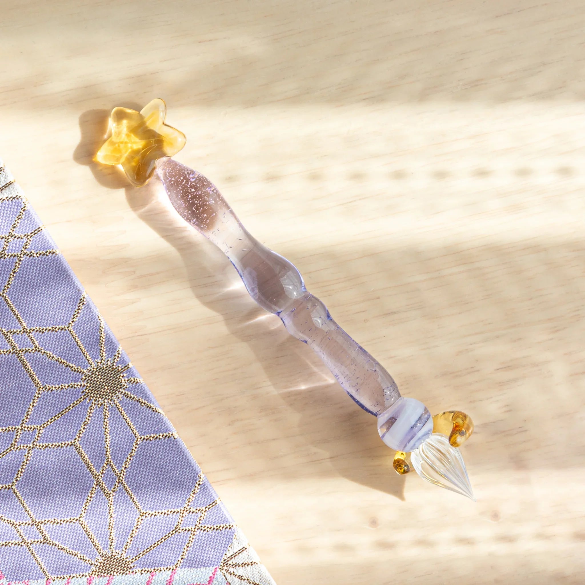 Purple Twilight Star glass dip pen set in profile view showing complete pen and matching gold star-shaped pen rest
