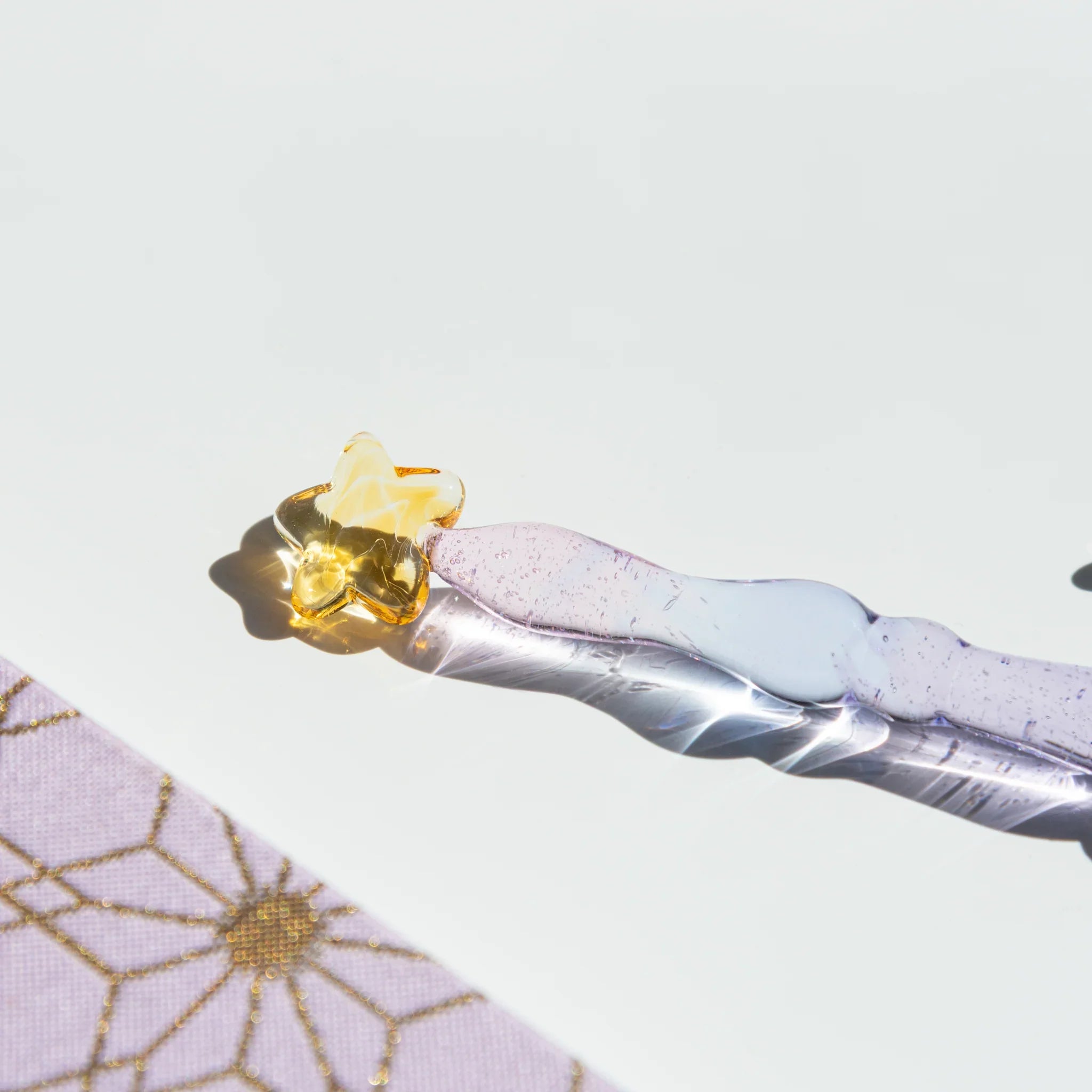 Twilight Star glass dip pen with purple-white striped barrel and gold star-shaped pen rest displayed on white background
