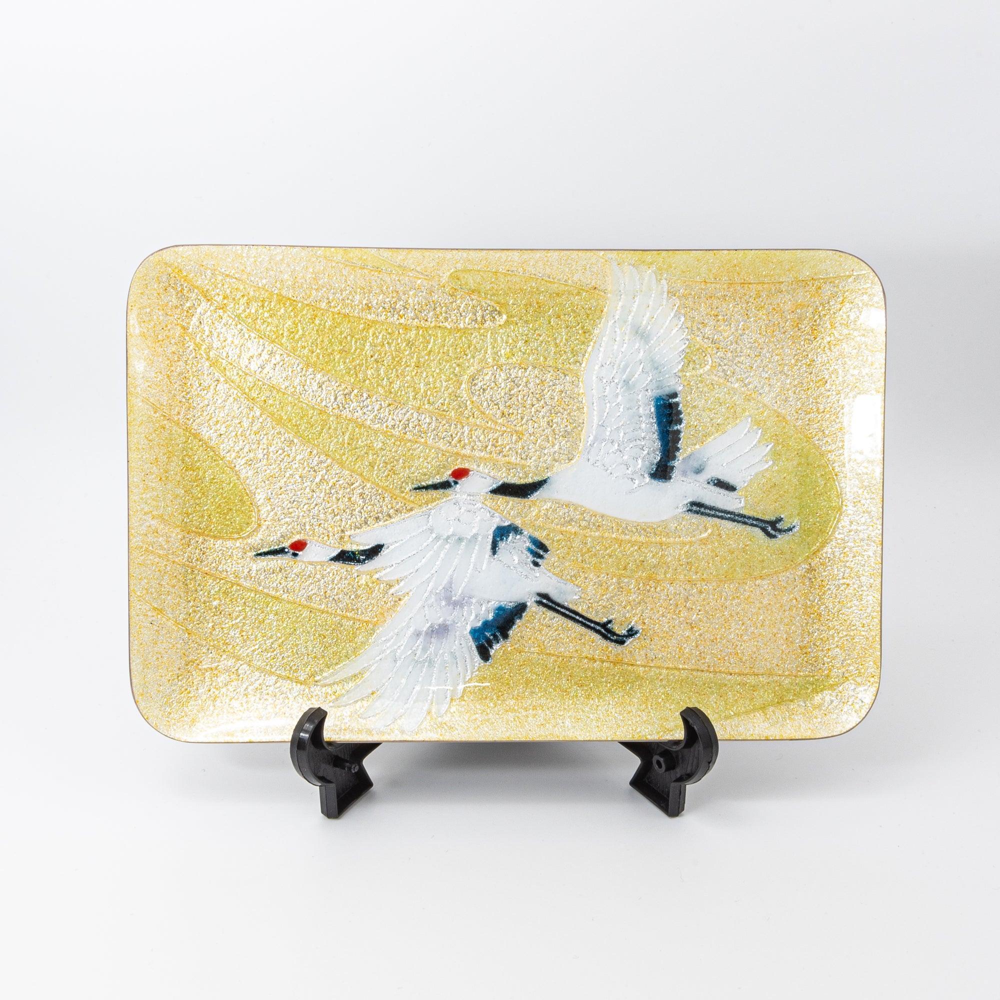 Japanese shippo ware large pen tray with twin red-crowned cranes in flight on gold, front view on black display stand