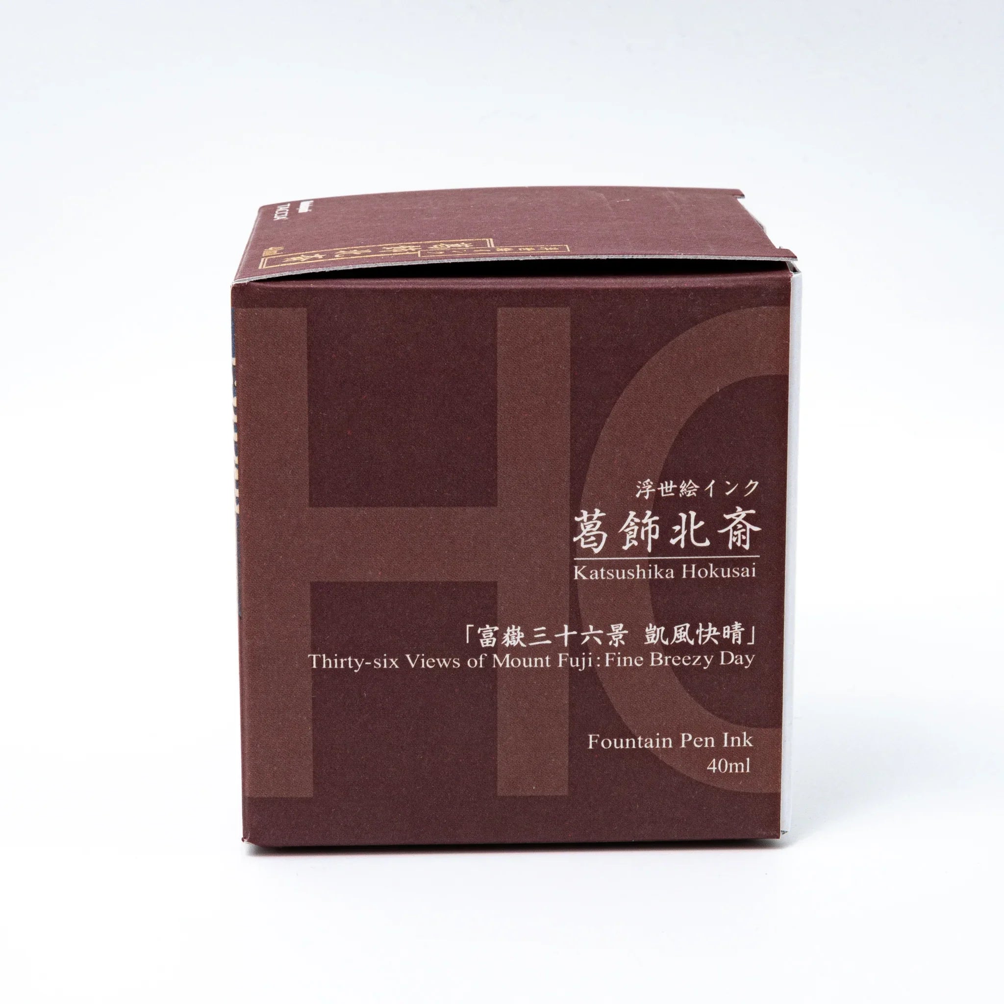TACCIA Hokusai-benitsuchi fountain pen ink with benitsuchi red hue showing bottle and color presentation on white surface
