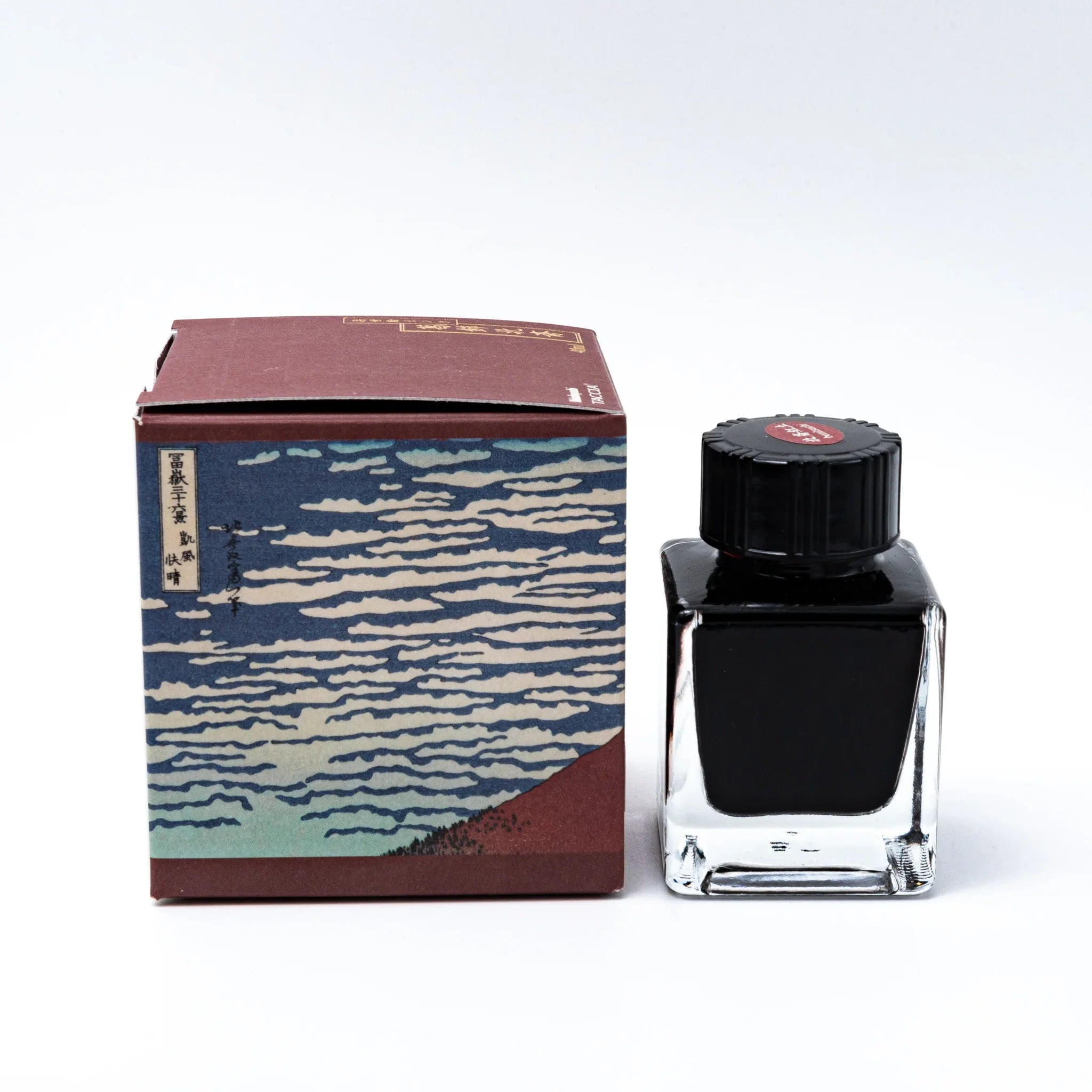 TACCIA Hokusai-benitsuchi fountain pen ink with rust vermillion tone and product details against neutral white backdrop