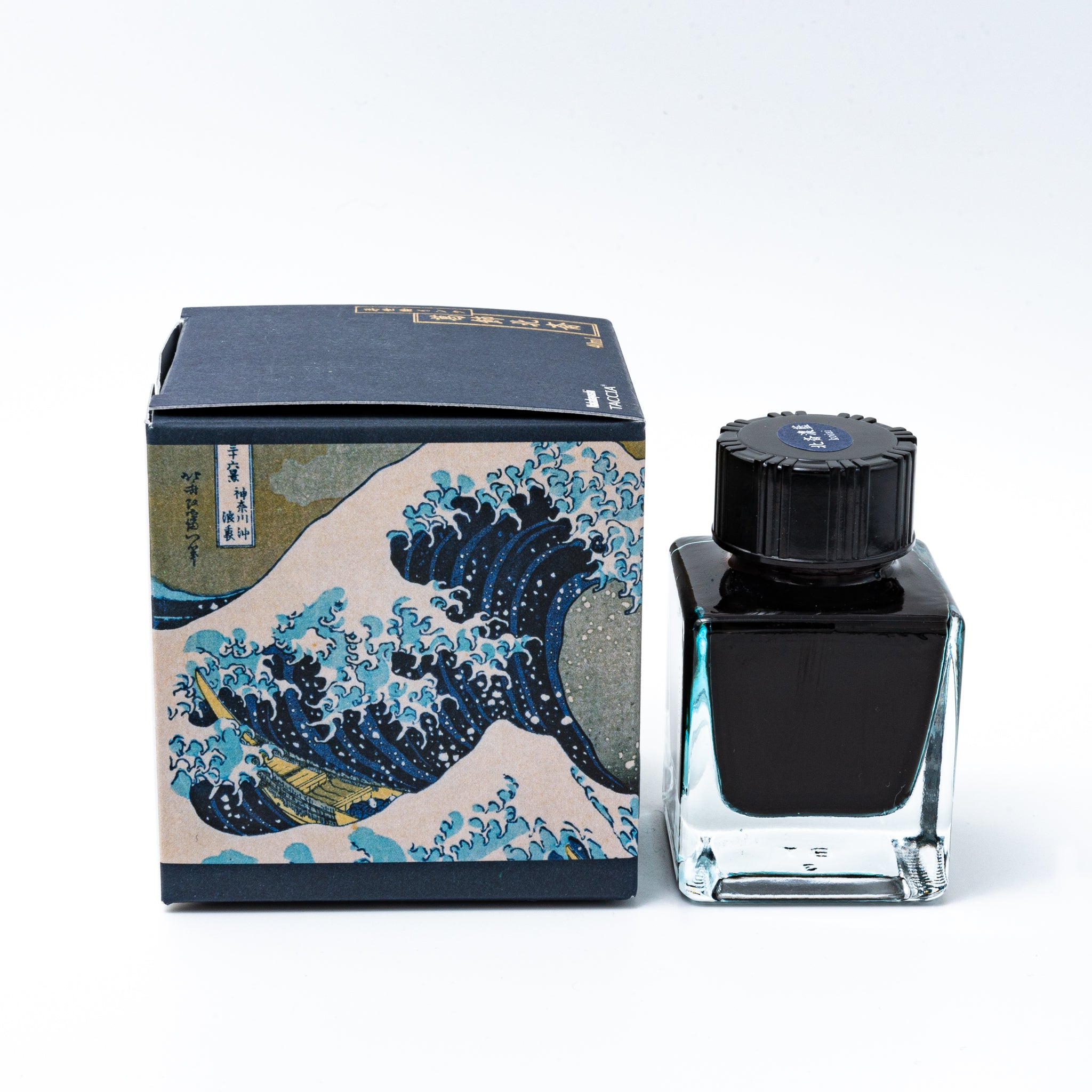Japanese stationery fountain pen ink. The packaging features Ukiyo-e art of a great wave with Mount Fuji. The glass bottle contains 40ml of deep blue "Koiai" ink.